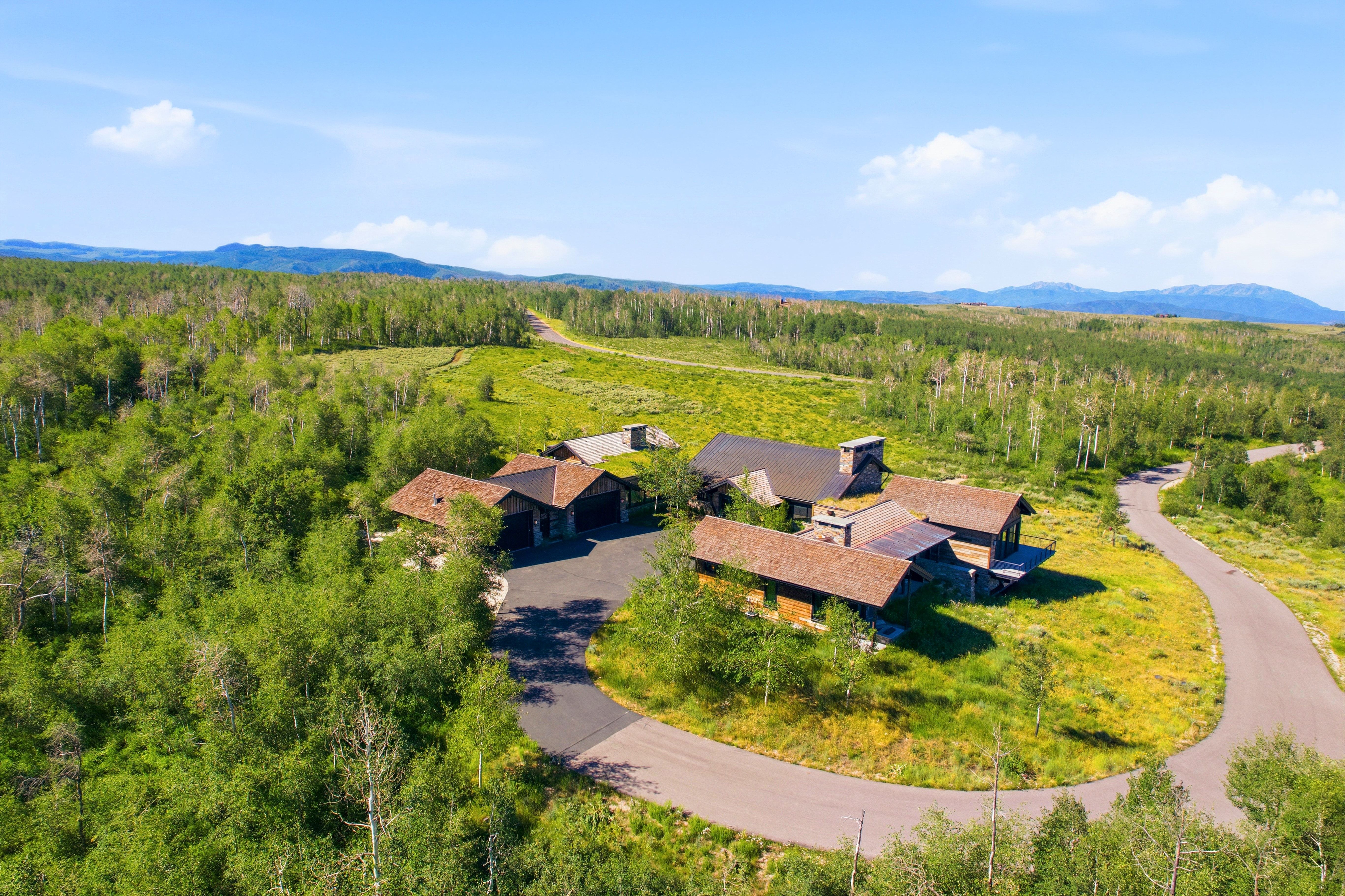 Sprawling property featuring multiple structures with natural wood siding and stone accents