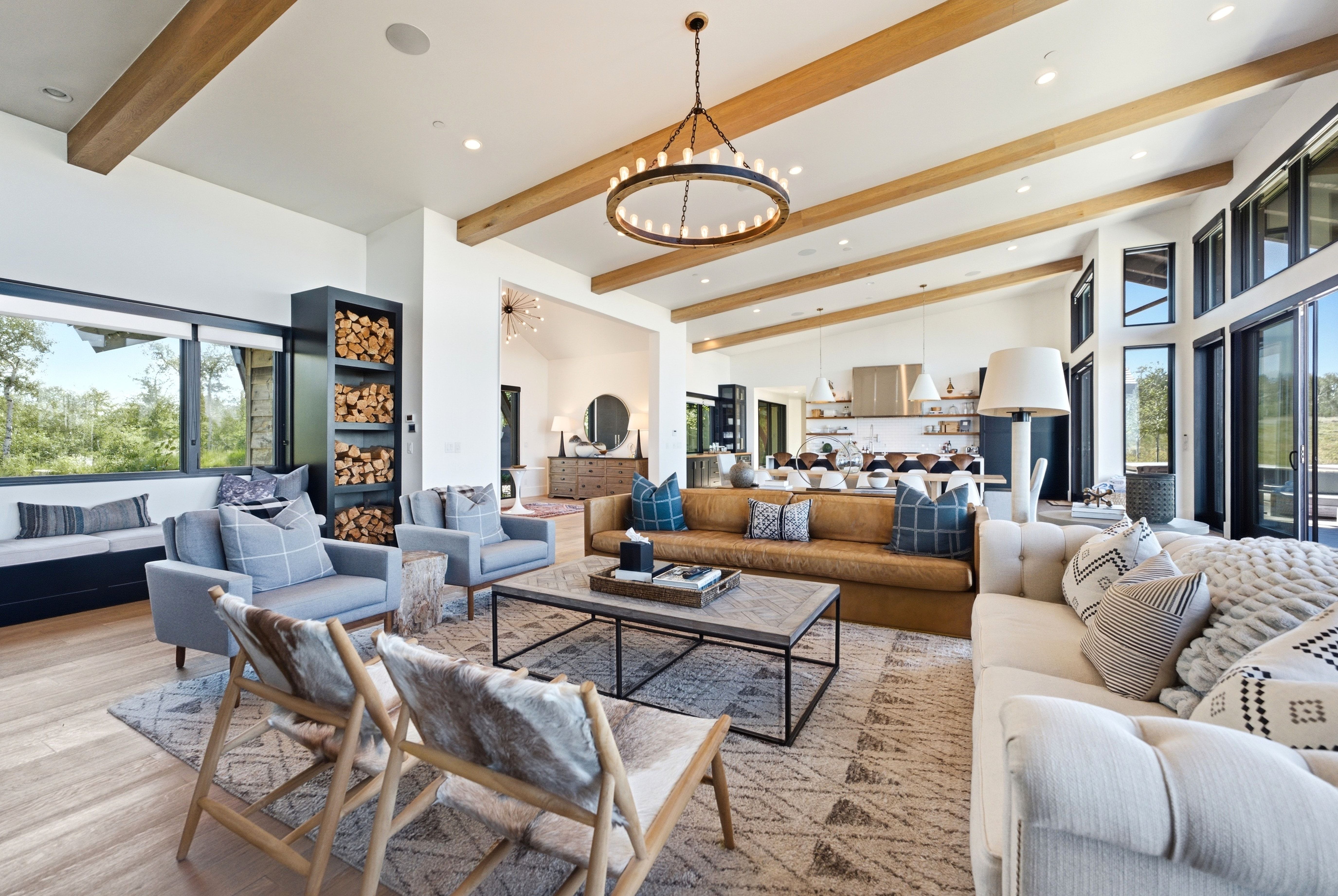Vaulted ceilings with exposed wood beams define this expansive open-concept living area