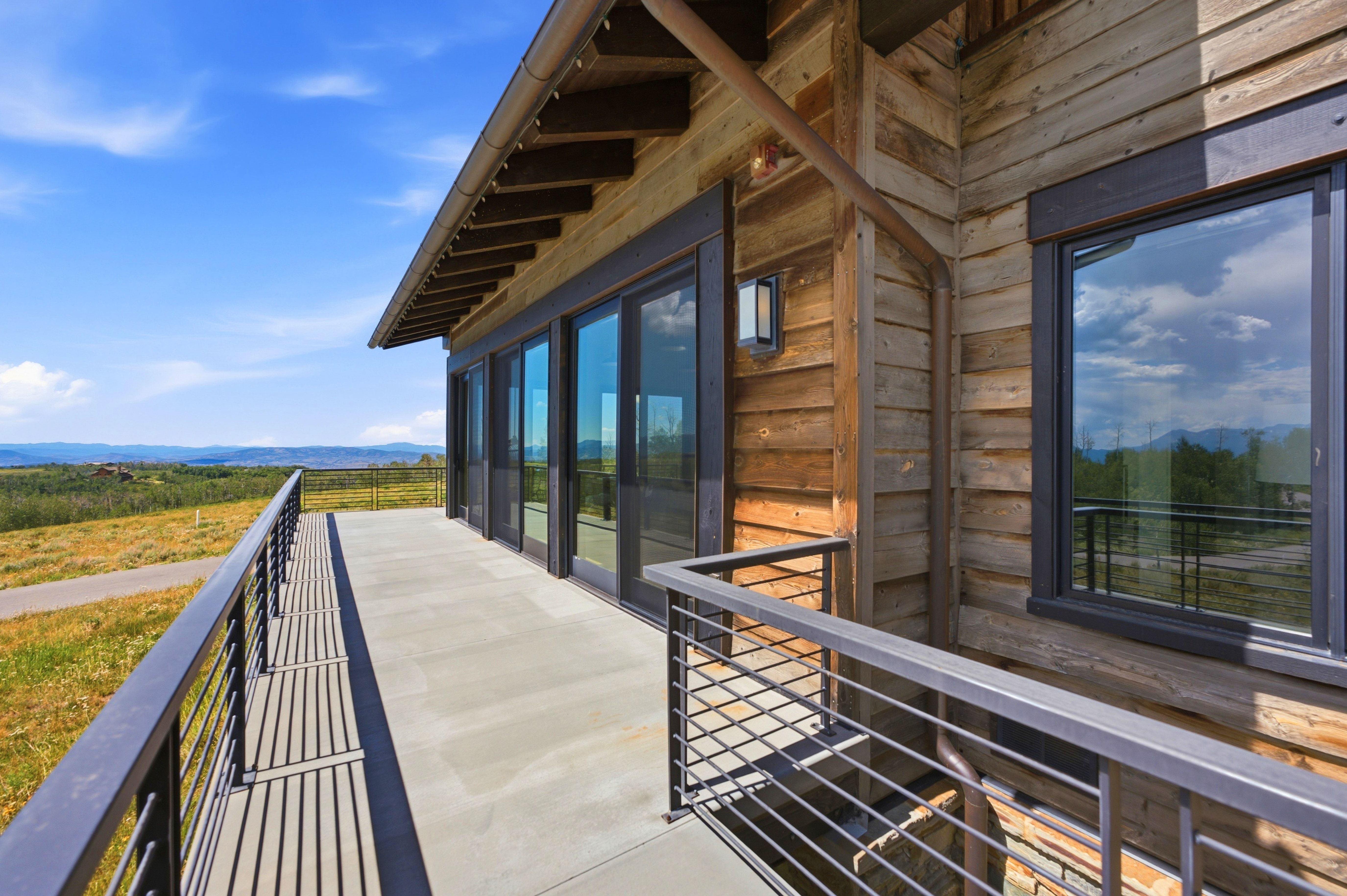 Expansive concrete balcony featuring contemporary metal railings