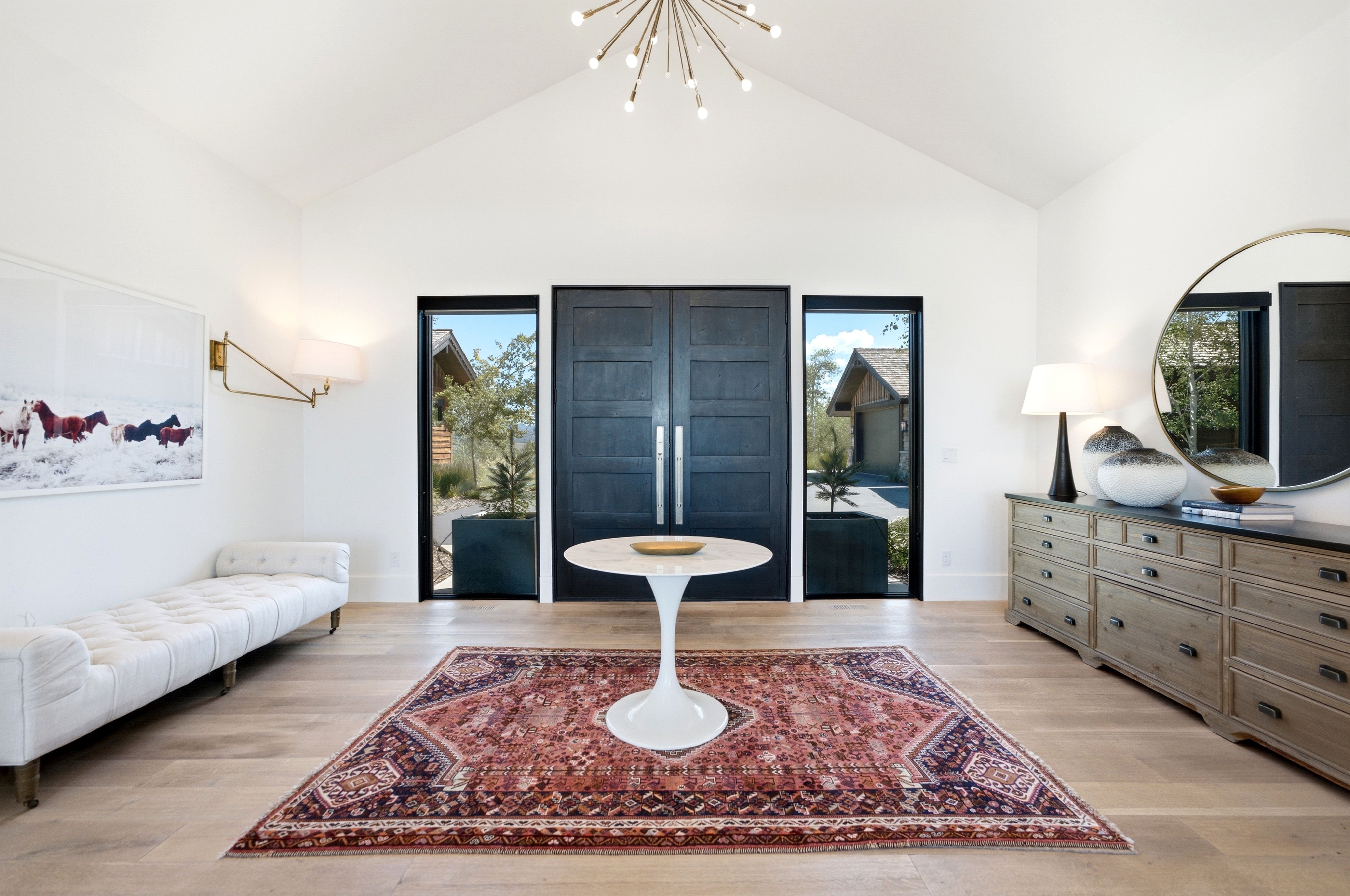 Vaulted ceiling entry featuring natural wood-finish flooring