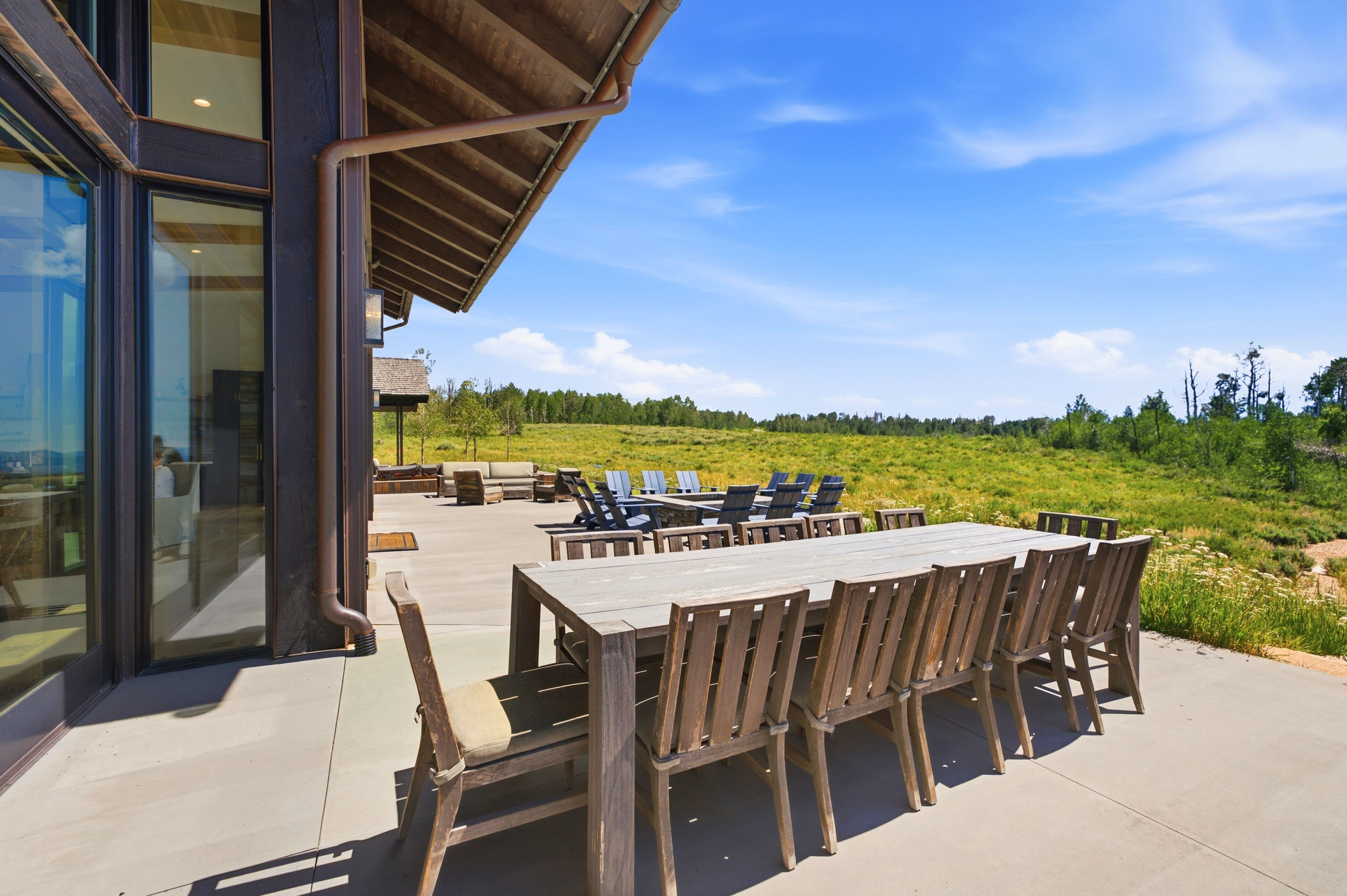 Expansive outdoor patio featuring a concrete surface and a partial overhang
