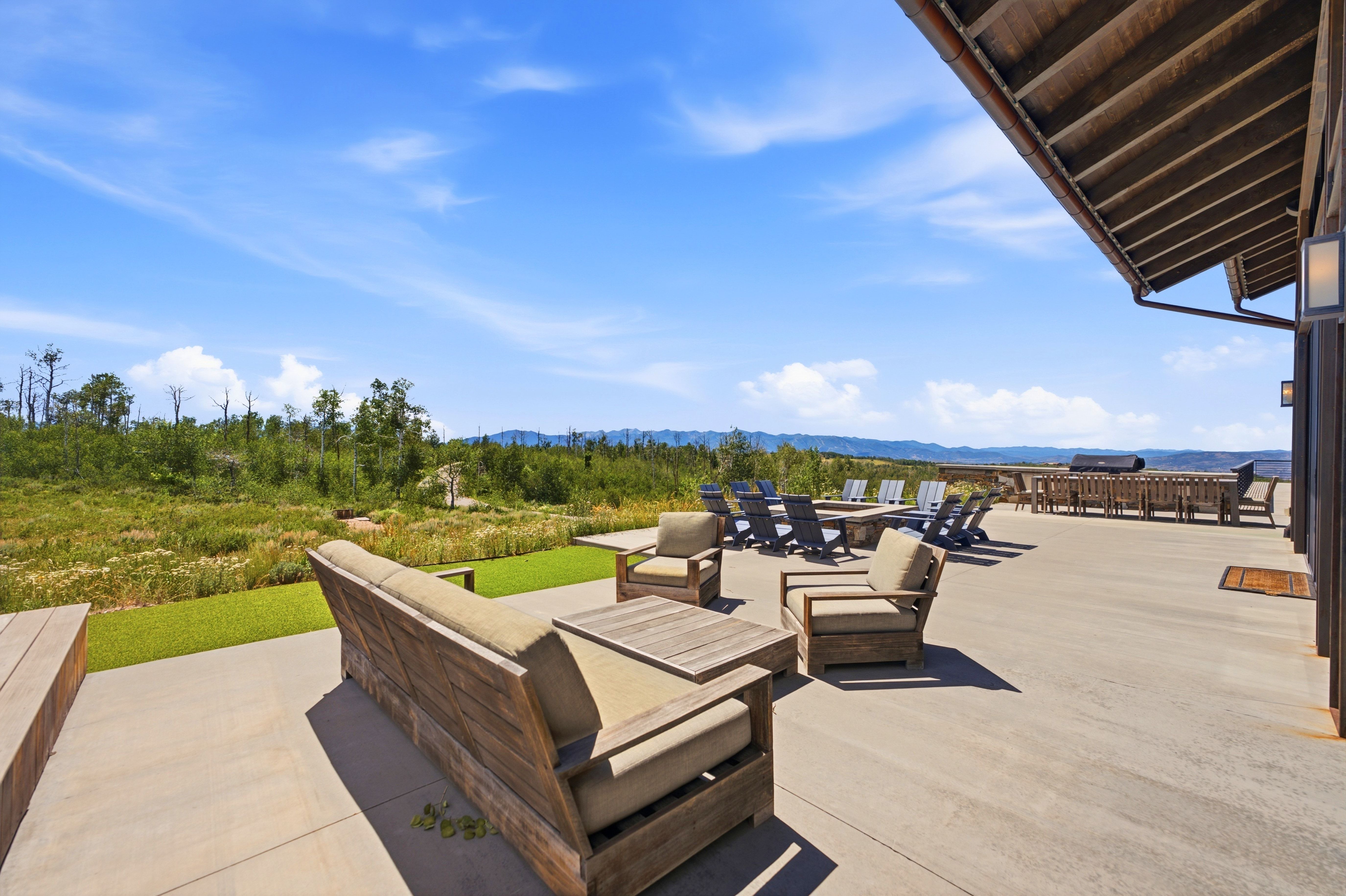 Expansive concrete patio offering multiple zones for outdoor enjoyment