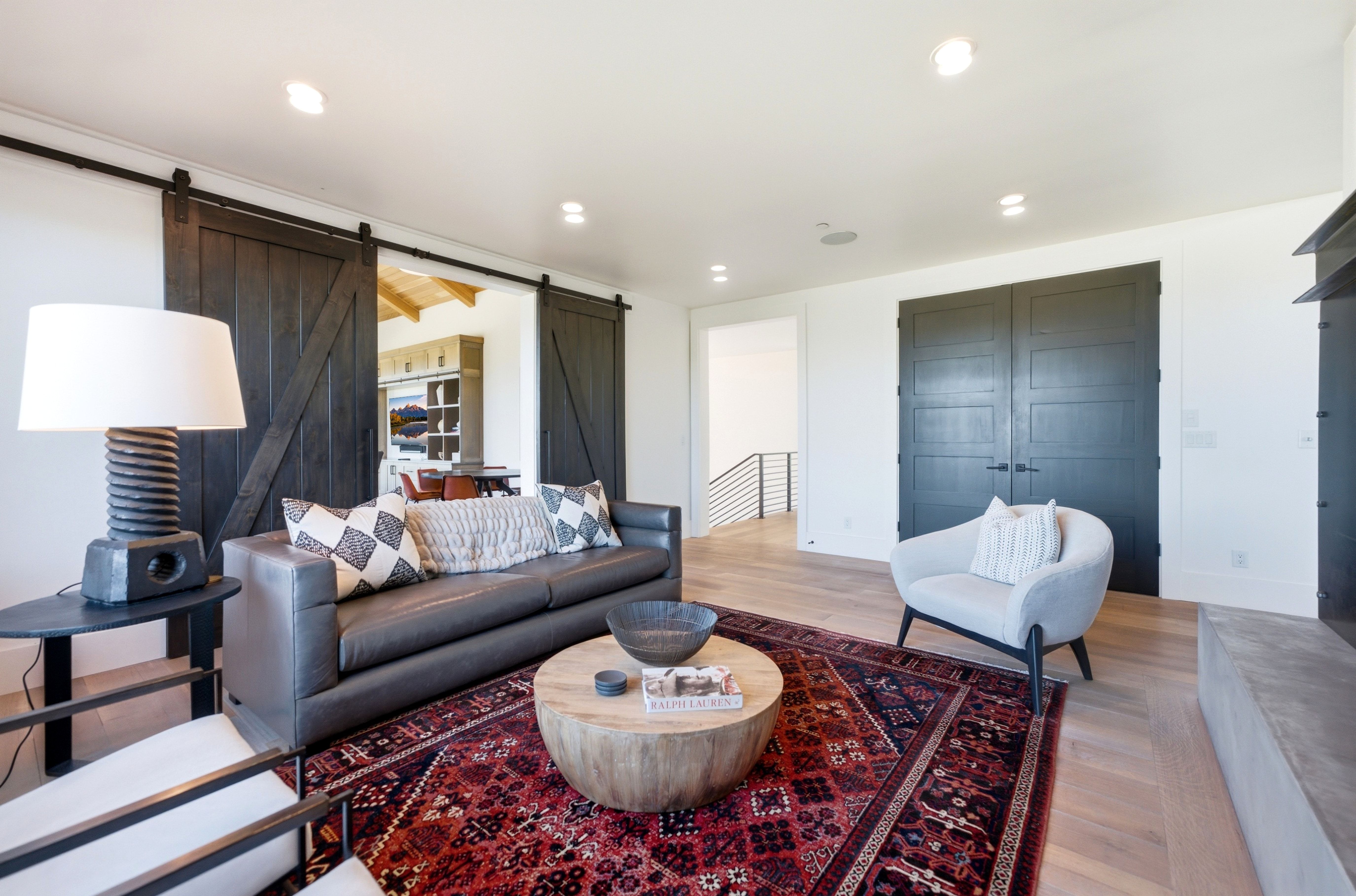 Living area with wood-finish flooring, recessed lighting, and a modern fireplace