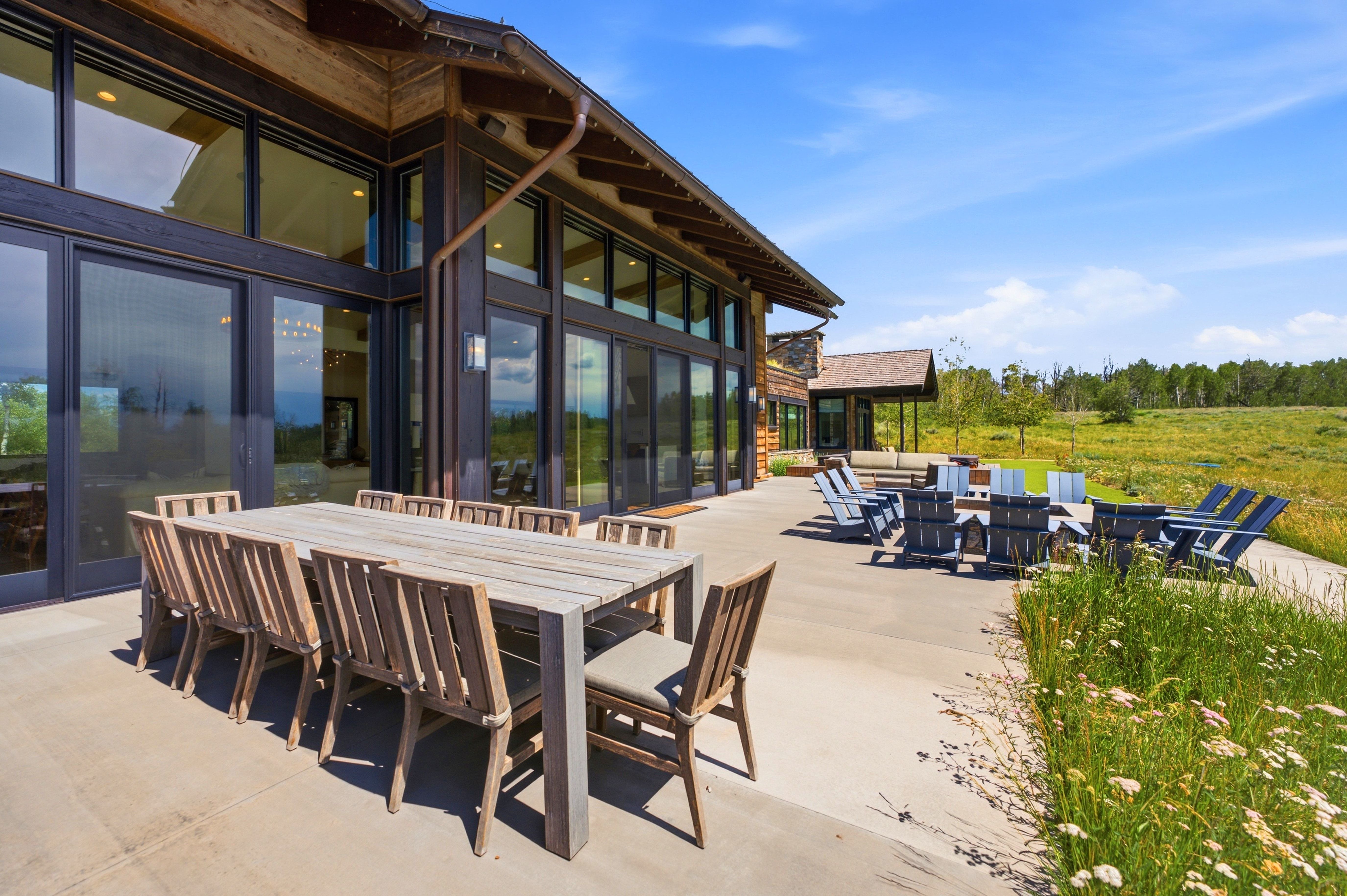 Expansive concrete patio with multiple outdoor living areas