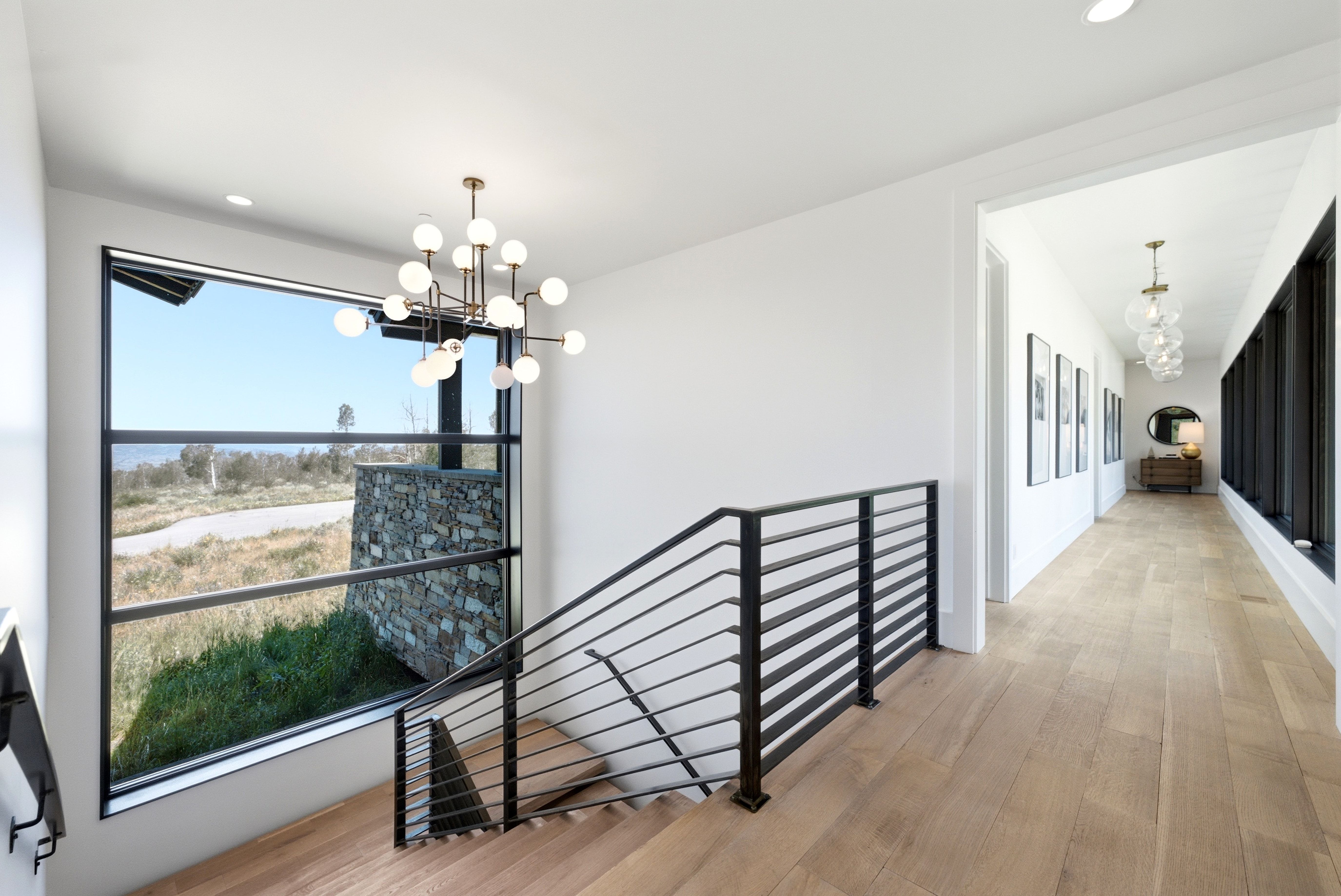 Staircase featuring wood-finish treads and contemporary black metal railings