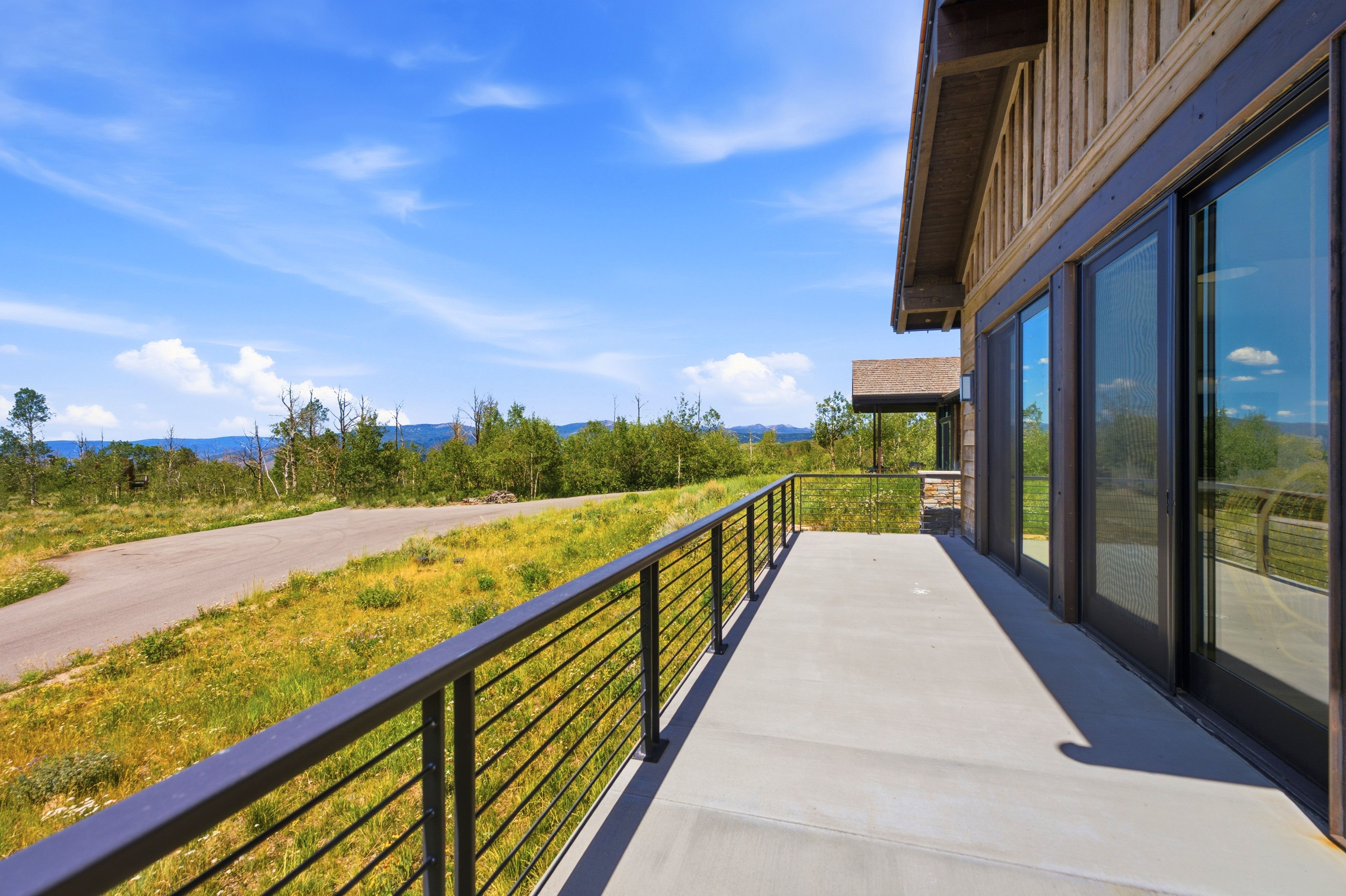 Expansive concrete patio with metal horizontal railing