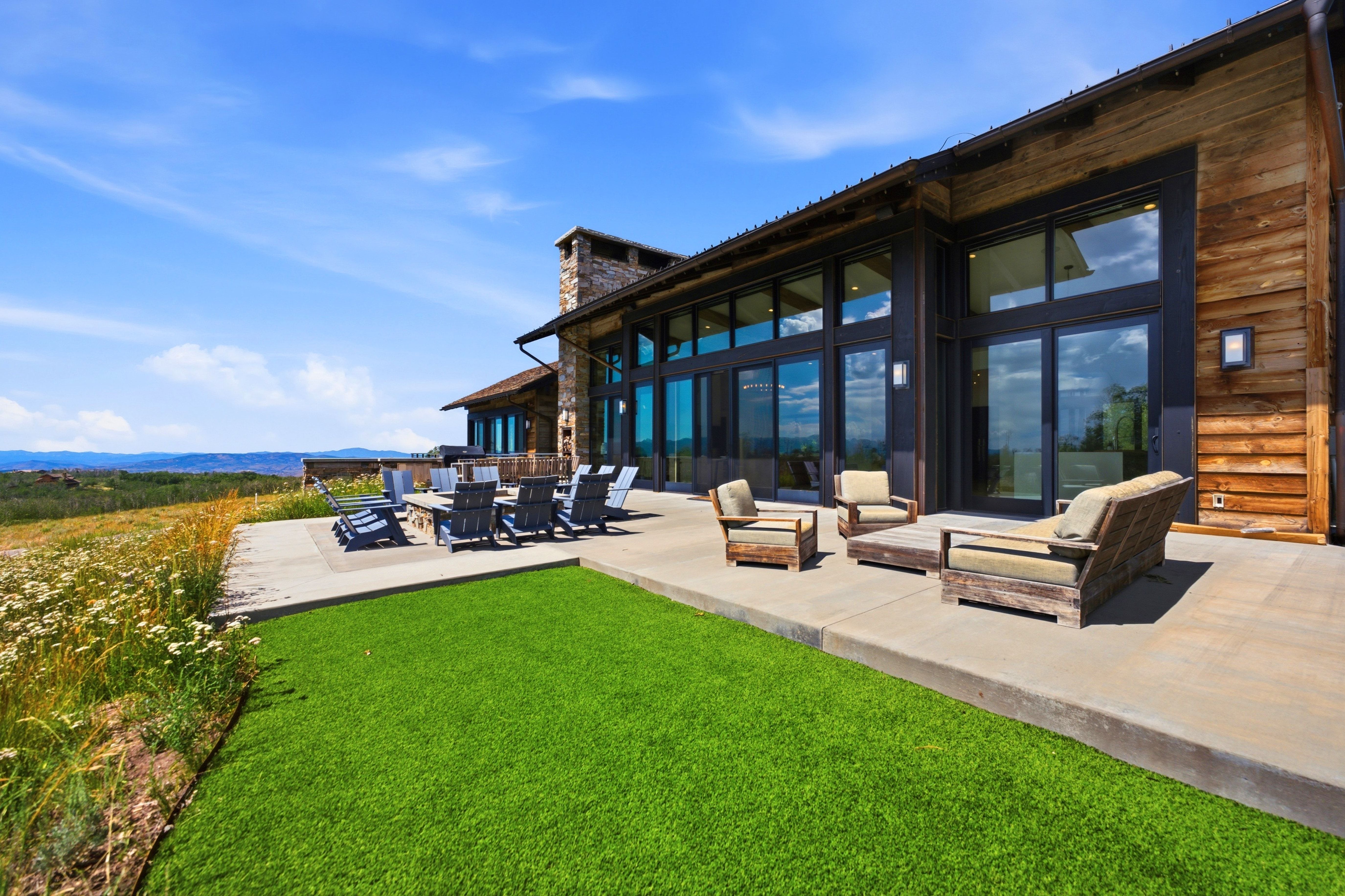 Expansive concrete patio with integrated artificial turf section