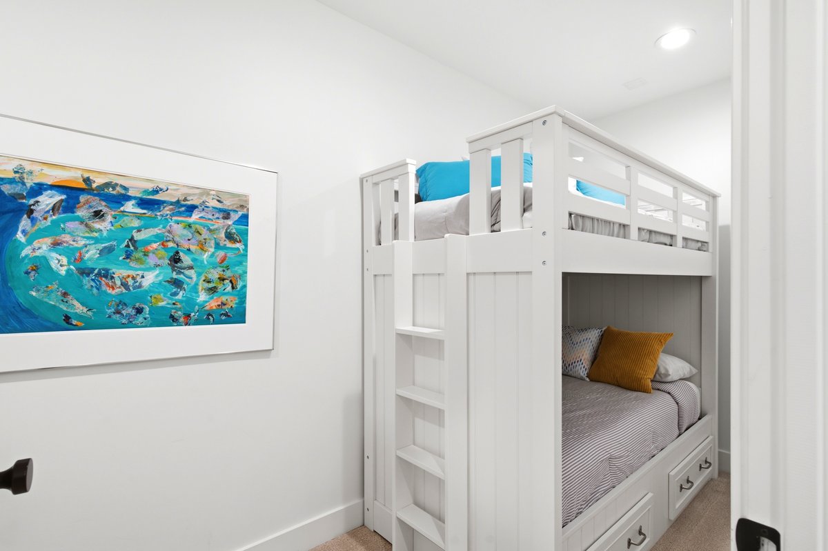 White bunk bed with built-in ladder and storage drawers