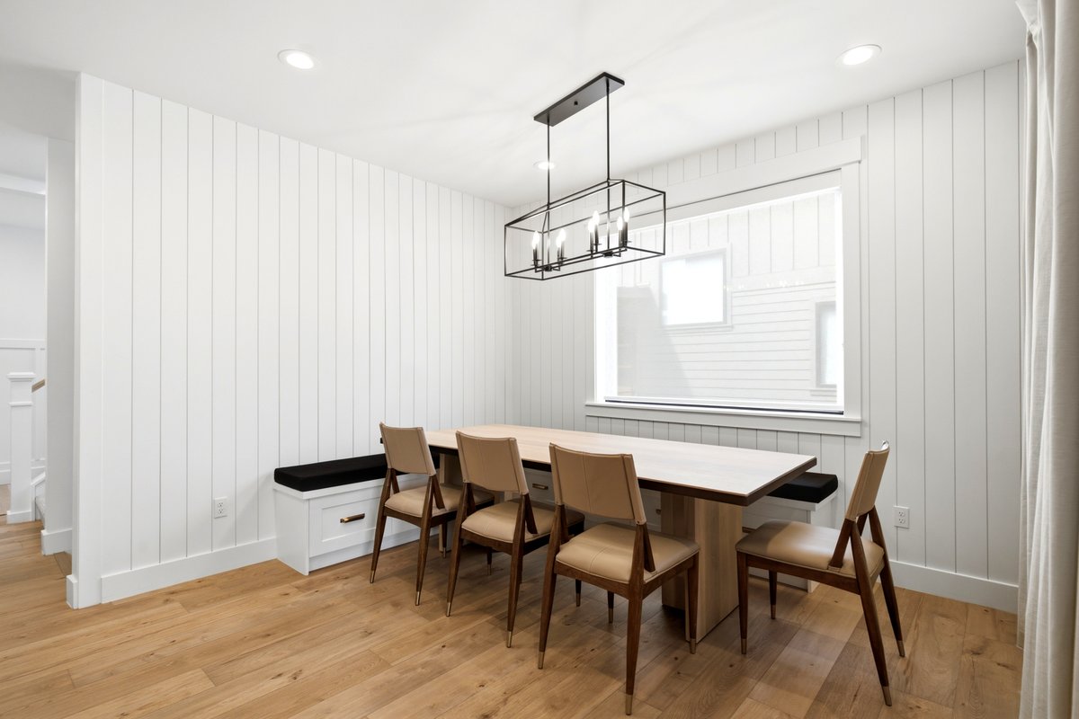 Dining area featuring white vertical shiplap paneling, wood-finish flooring, and recessed ceiling lighting