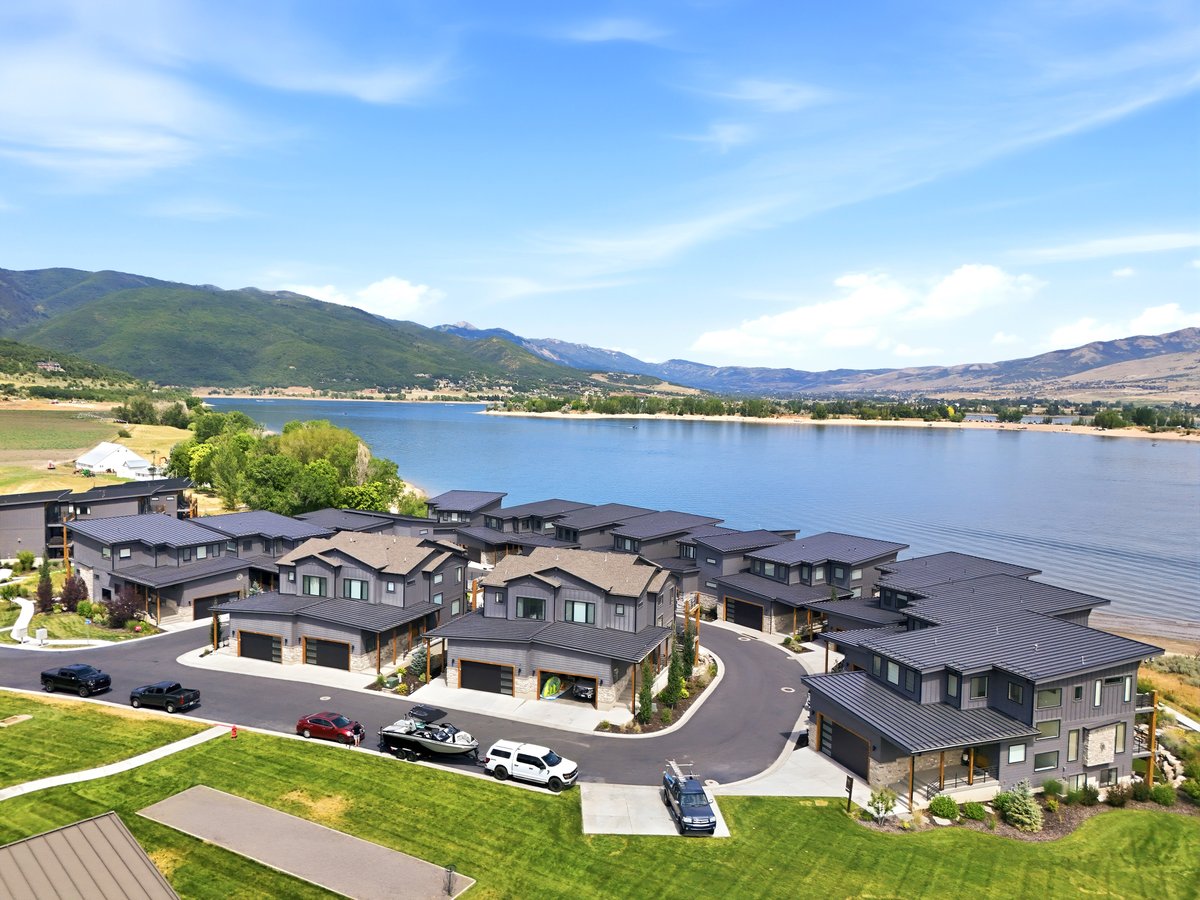 Modern residential development featuring multi-story structures with dark facades and complementary roofing