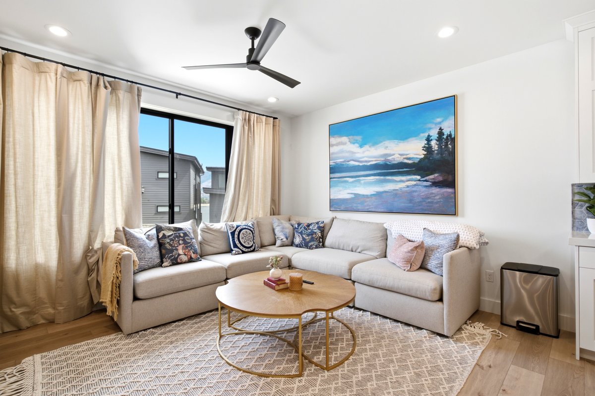 Light wood-finish flooring complements the neutral color palette of this living space