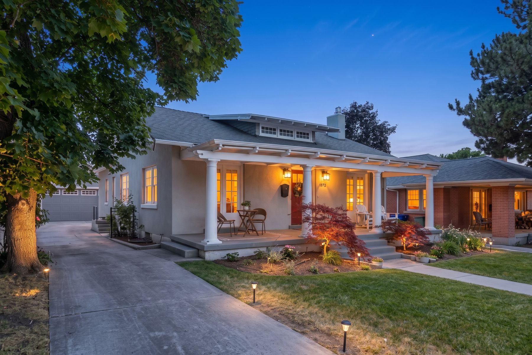 Stucco exterior with a covered porch featuring white columns