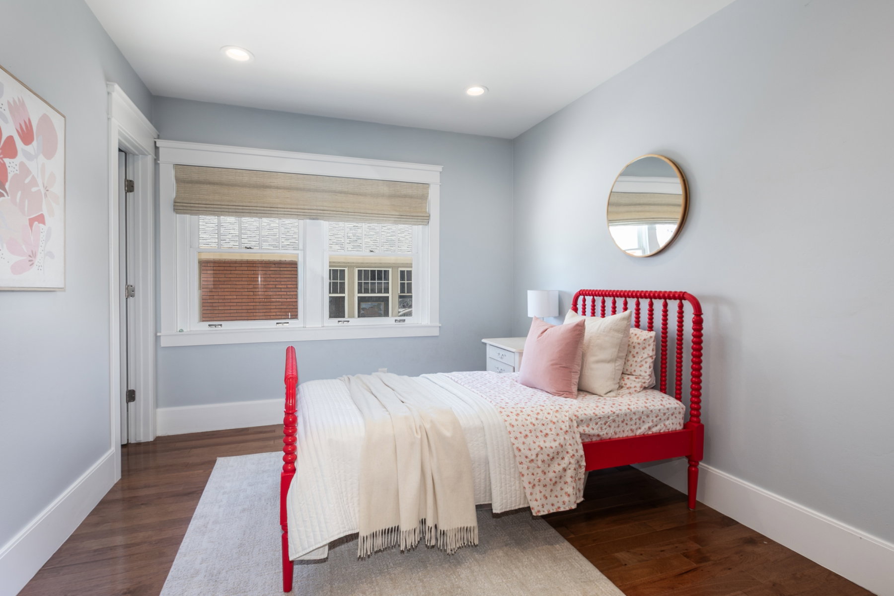 Bedroom featuring wood-finish flooring, recessed lighting, and a window with a woven Roman shade