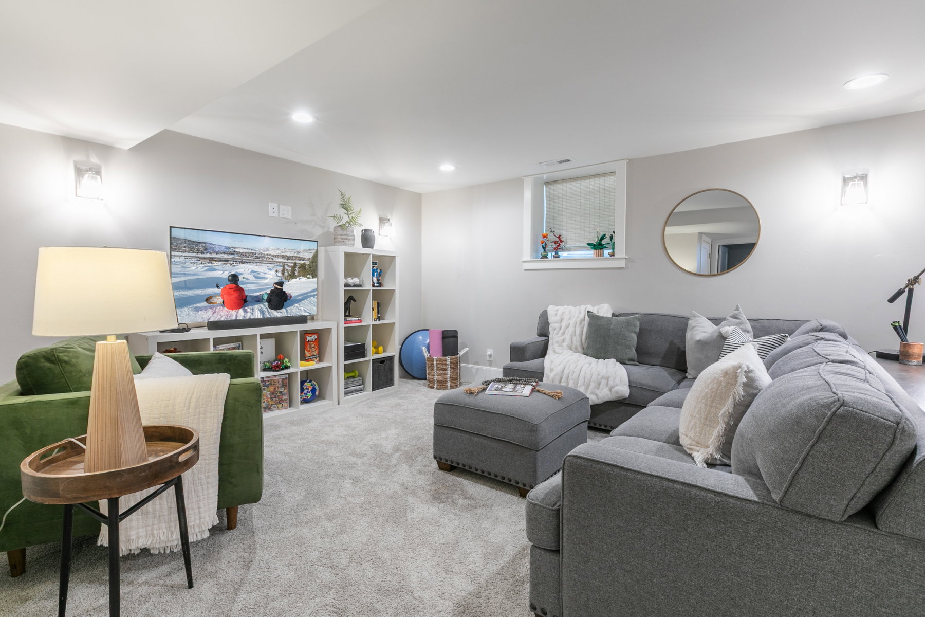 Finished lower level featuring recessed lighting, plush carpeting, built-in shelving, and a bright window