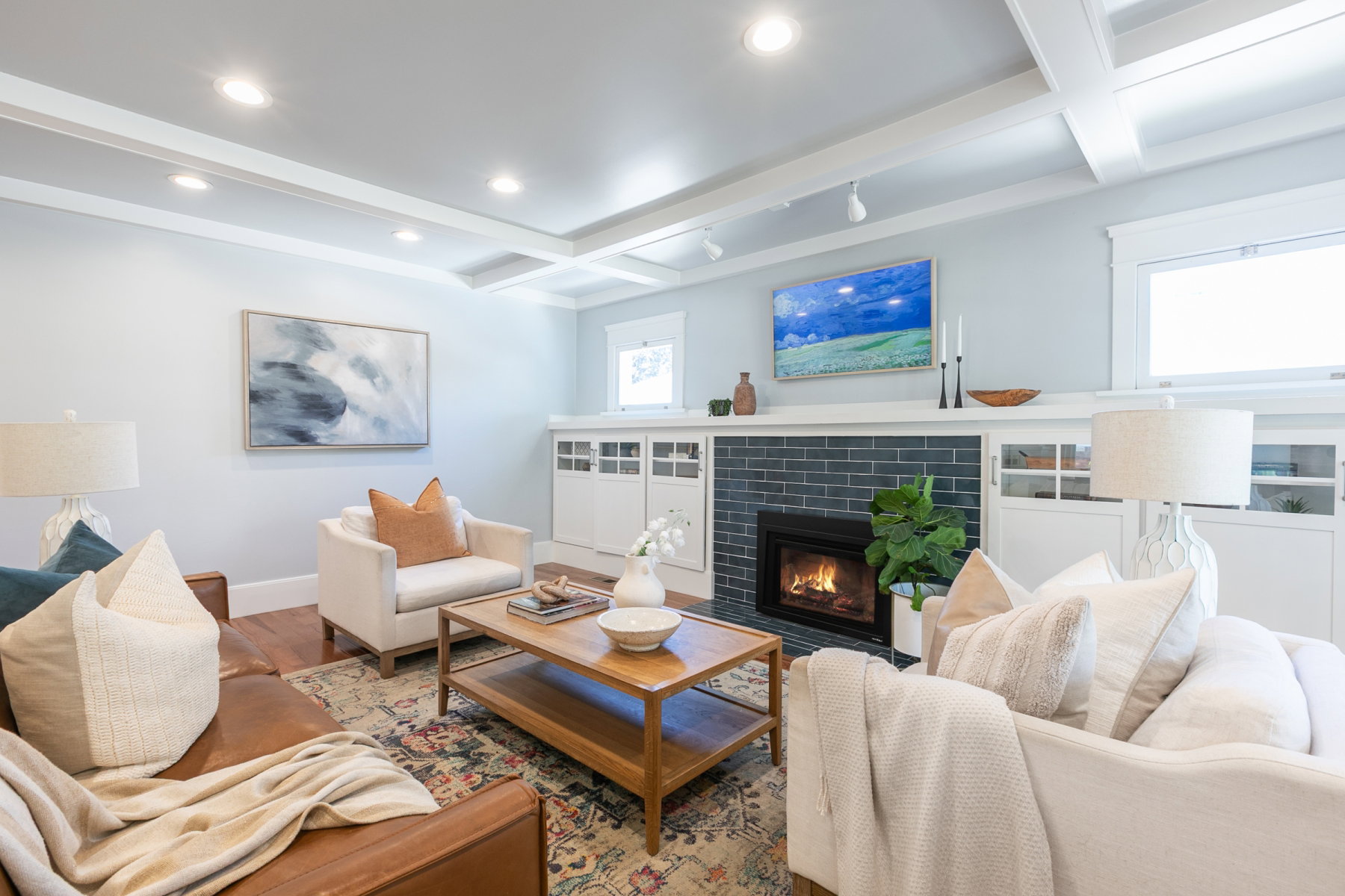Living area featuring a coffered ceiling with recessed lighting