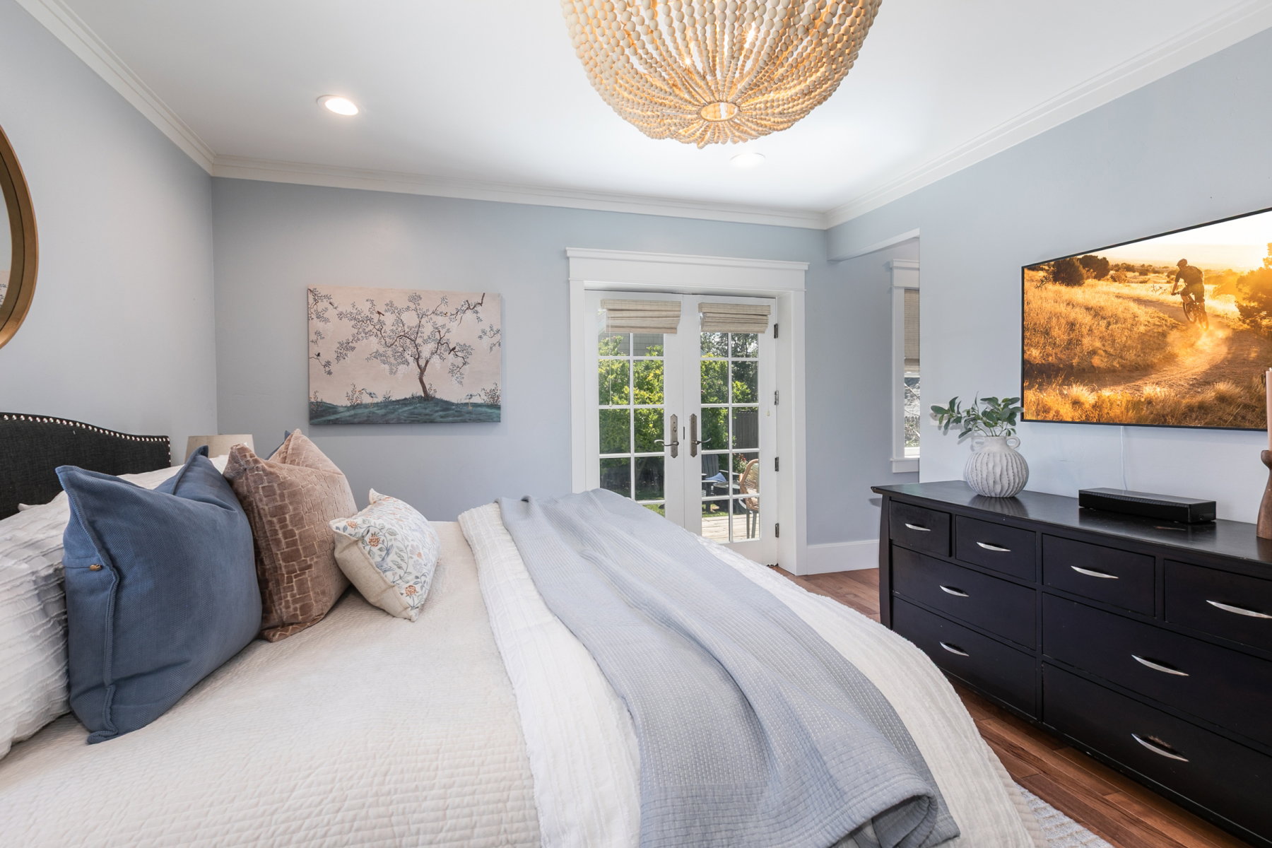 French doors opening to exterior, hardwood flooring, recessed lighting, crown molding, and a beaded chandelier