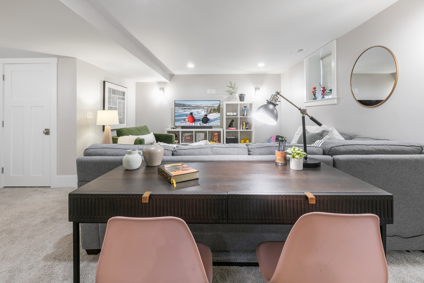 Versatile room featuring light grey carpeting, recessed lighting, and a white panel door