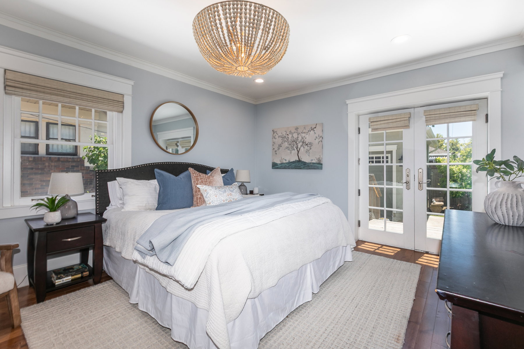 Bedroom featuring a decorative chandelier and light blue walls