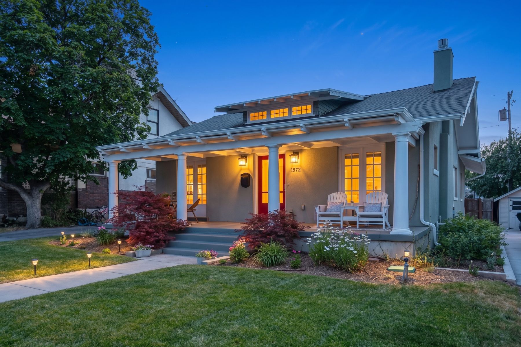Charming bungalow facade with a covered front porch featuring white columns