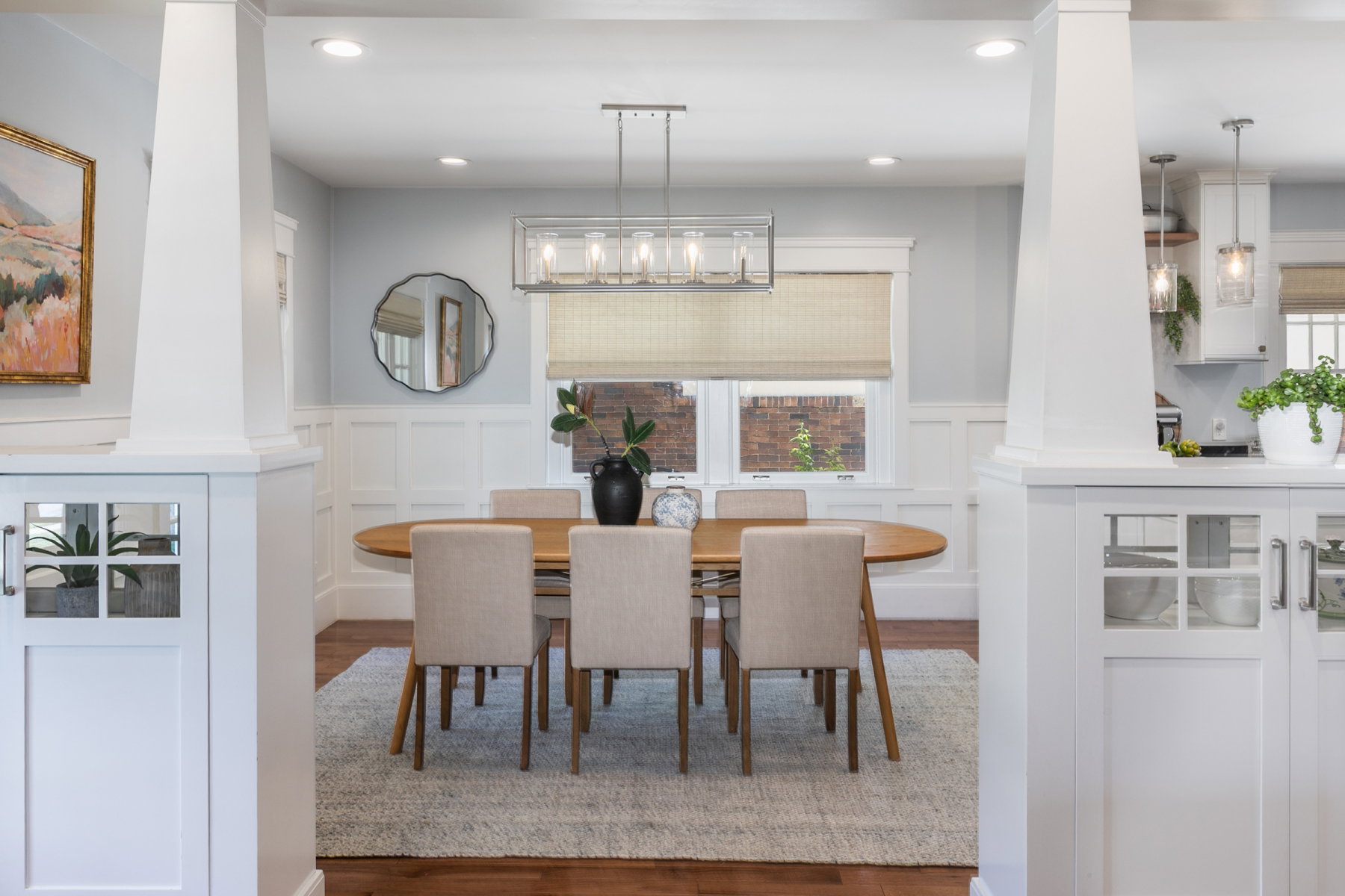 Dining area with wood-finish flooring and wainscoting
