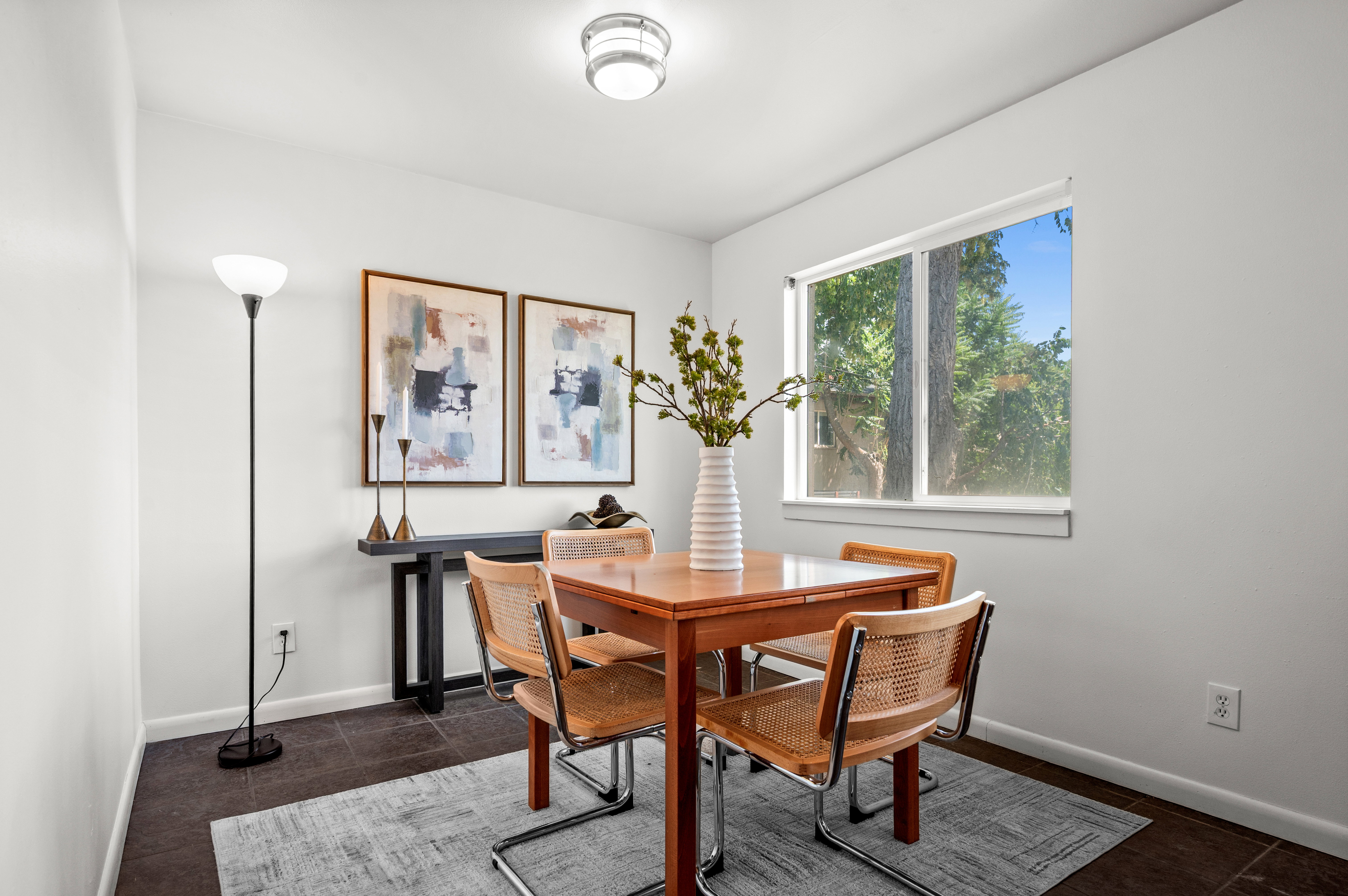 Dining area with dark tile flooring and a rectangular window