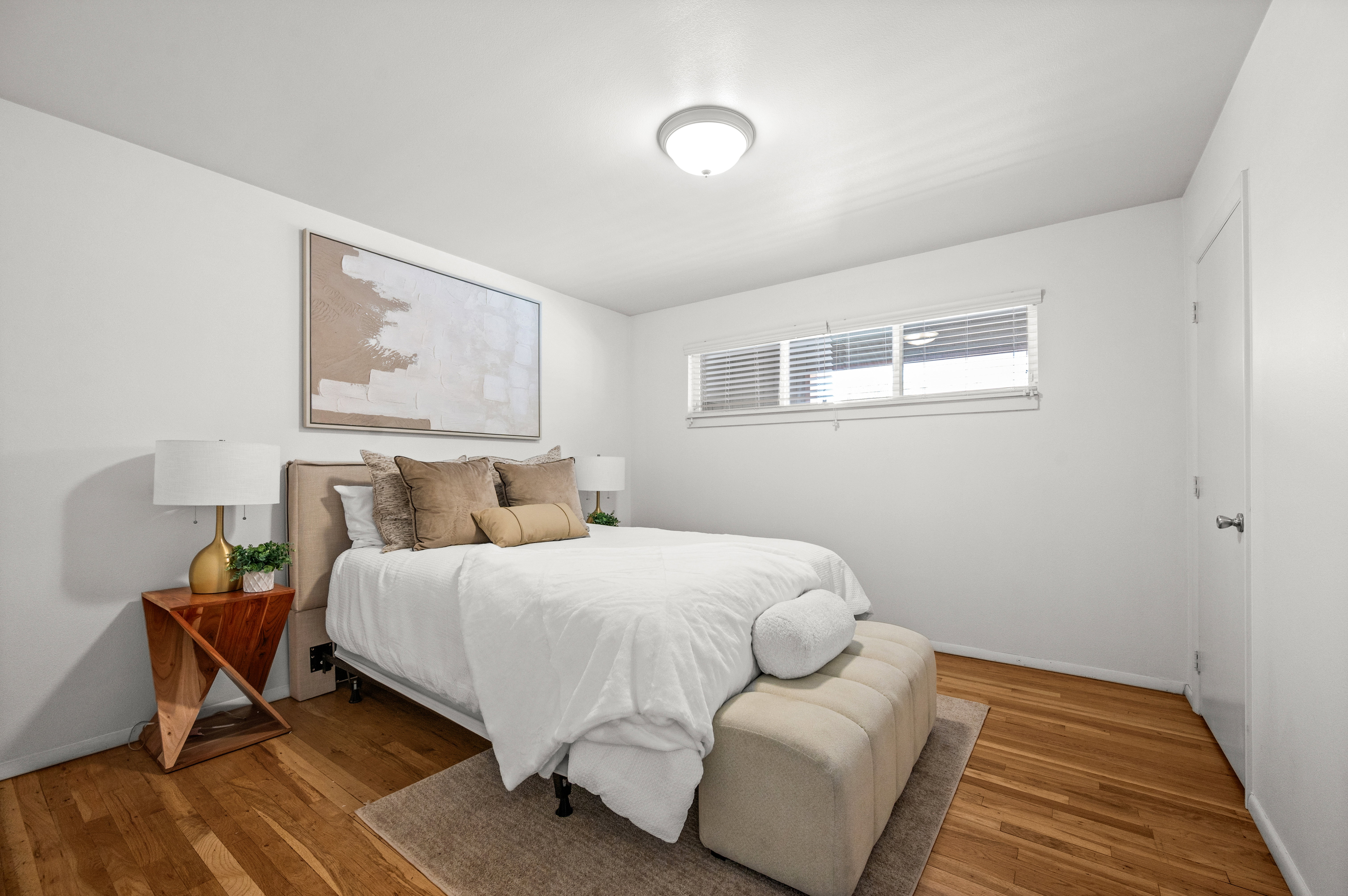 Bright interior room featuring wood-finish flooring and a neutral color palette