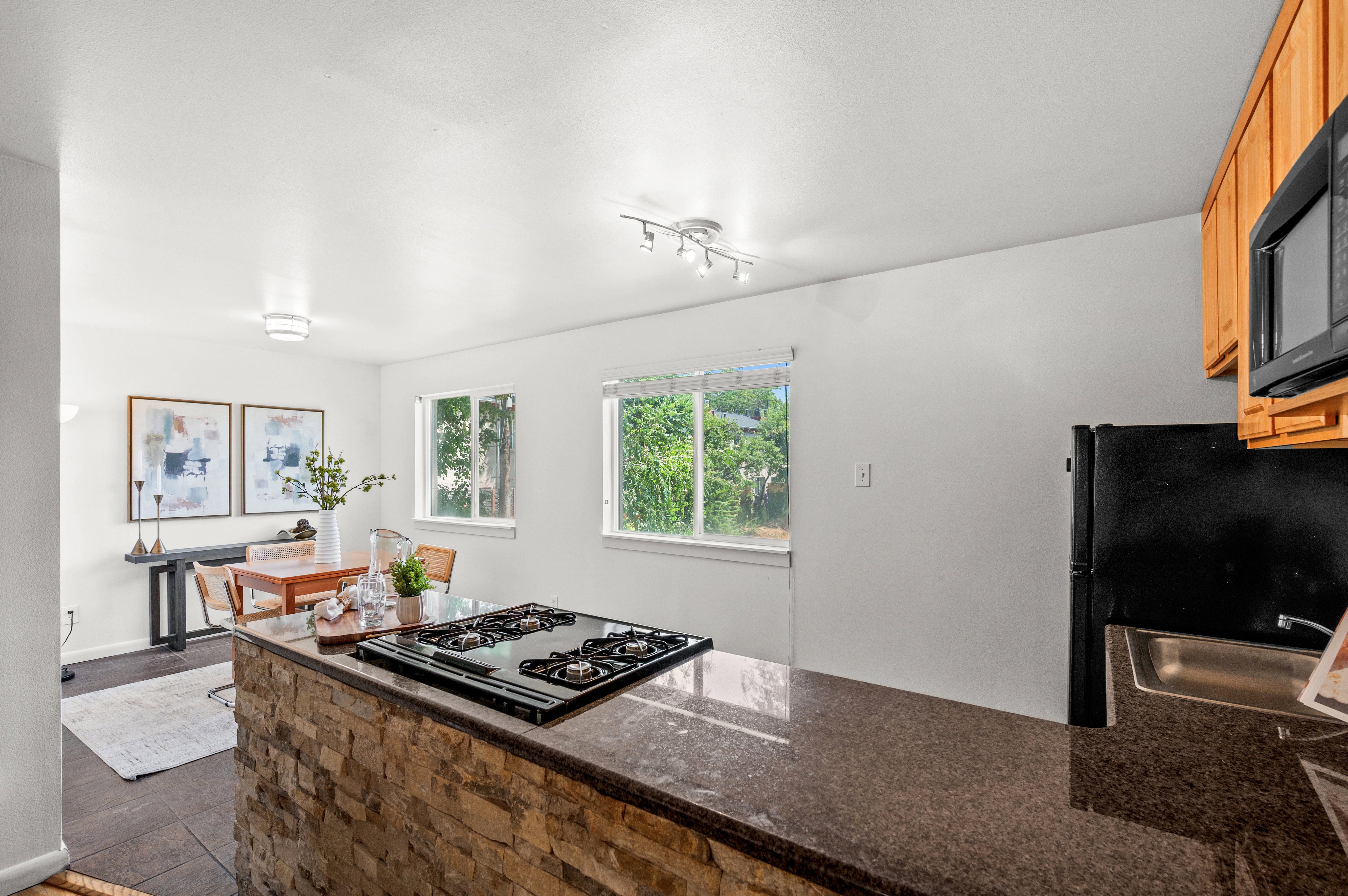 Kitchen island with a built-in gas cooktop and stacked stone base
