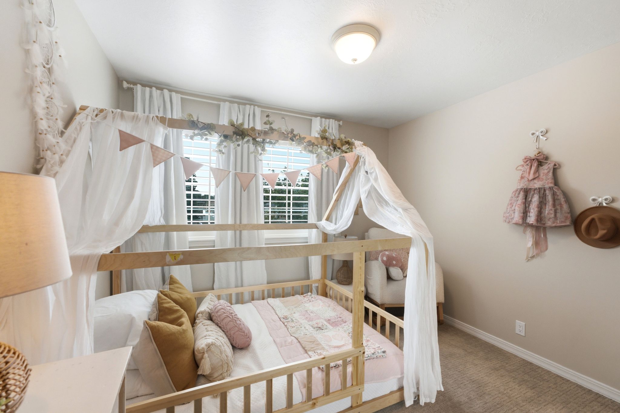 Carpeted bedroom with neutral wall tones and a flush-mount ceiling light