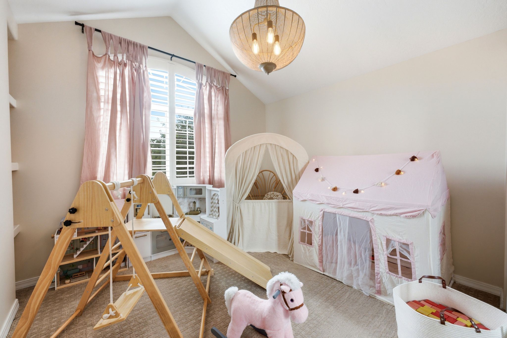 Room featuring vaulted ceiling, recessed shelving, and carpet flooring