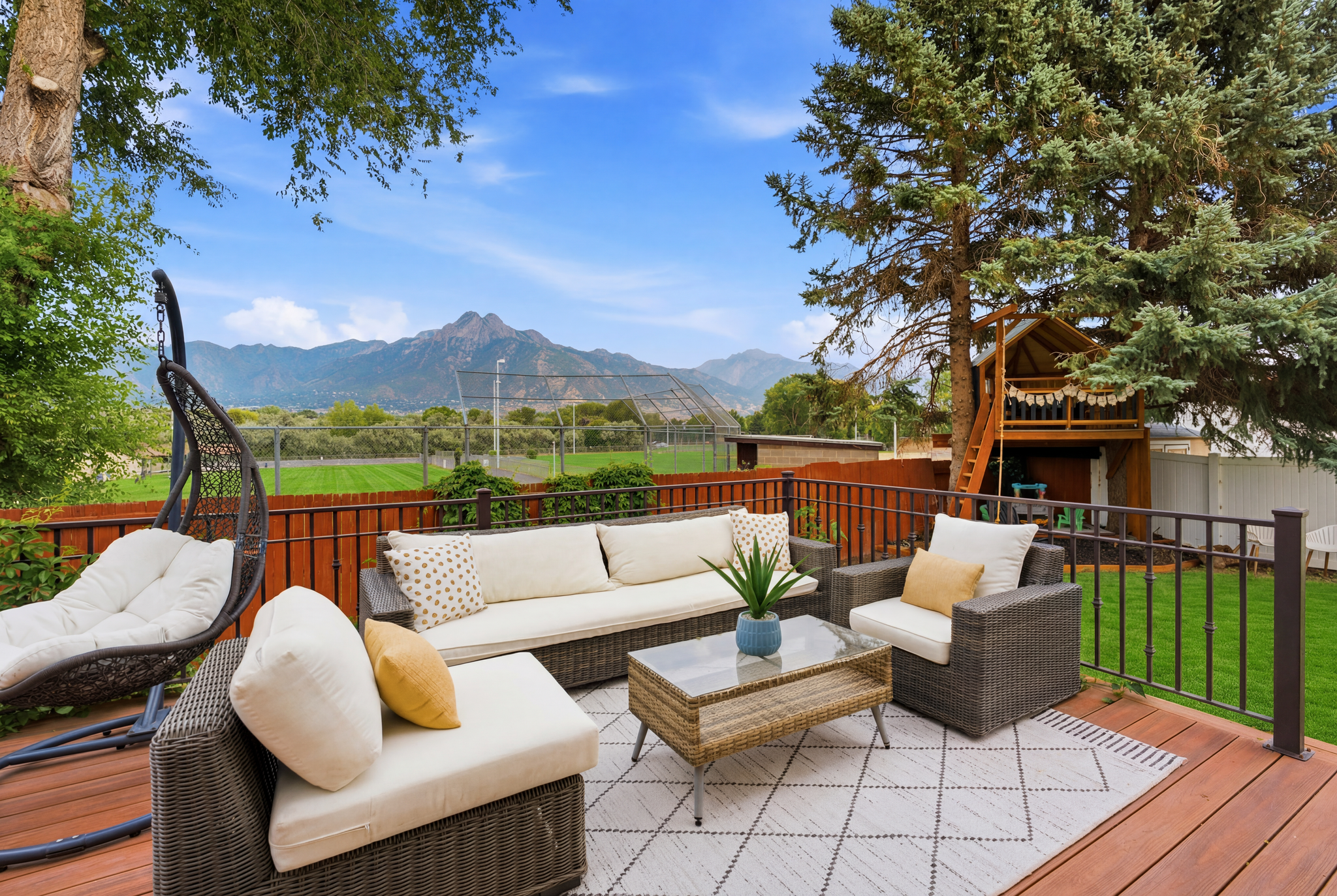 Expansive wood-finish deck with black metal railings
