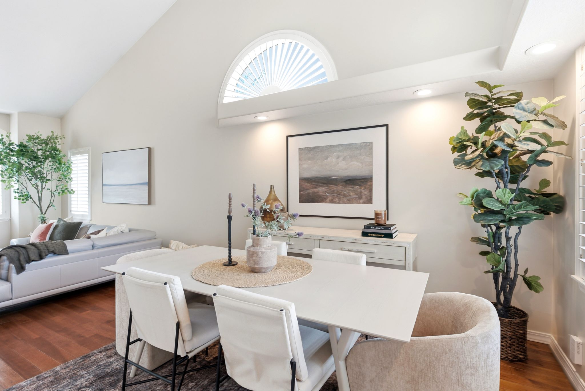 Spacious interior featuring vaulted ceilings, recessed lighting, and wood-finish flooring