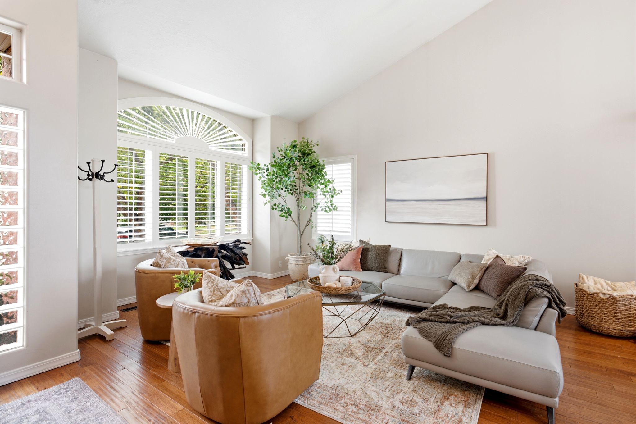 Living area featuring rich wood-finish flooring and vaulted ceilings