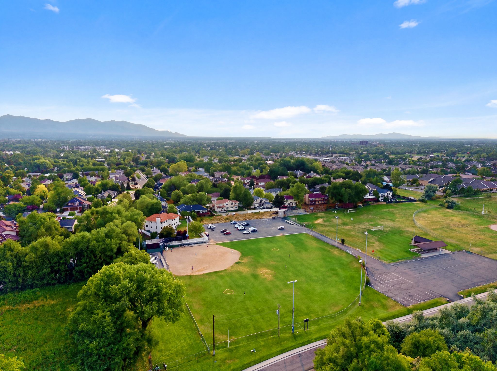 Expansive green spaces featuring a baseball diamond and additional sports fields