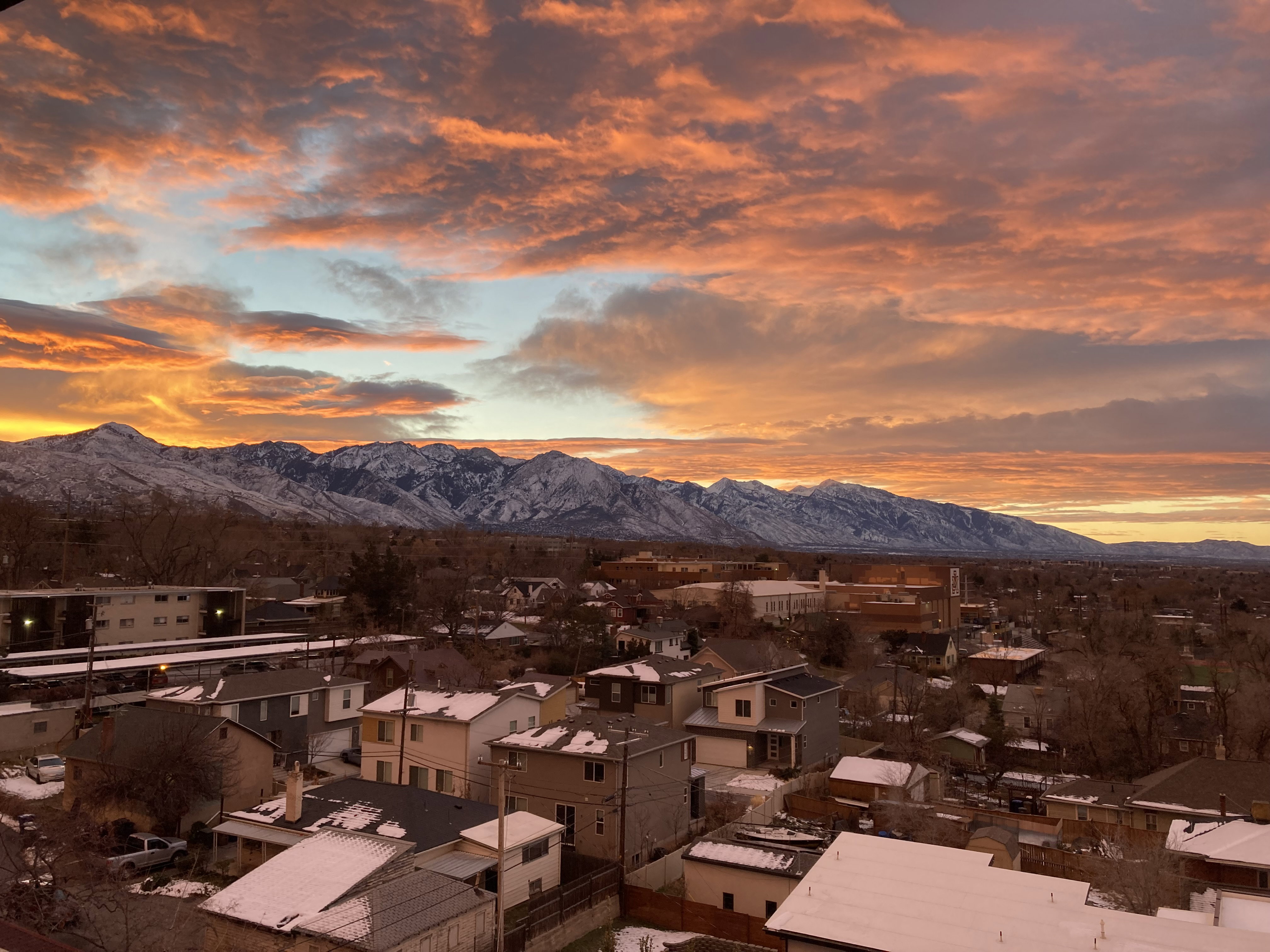 Mountain range backdrop with a vibrant, cloud-filled sky