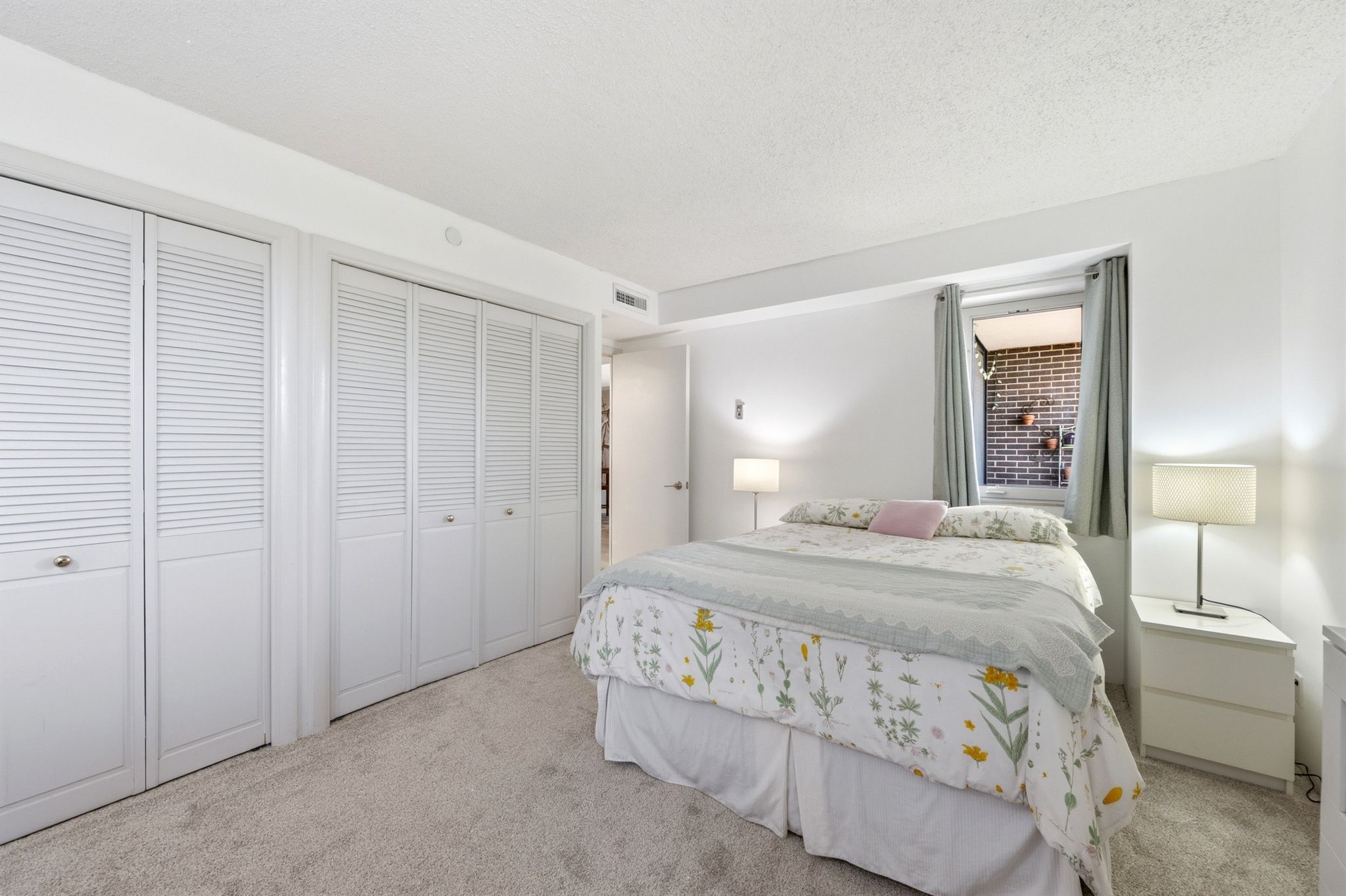 Wall-to-wall carpeting and louvered bifold closet doors