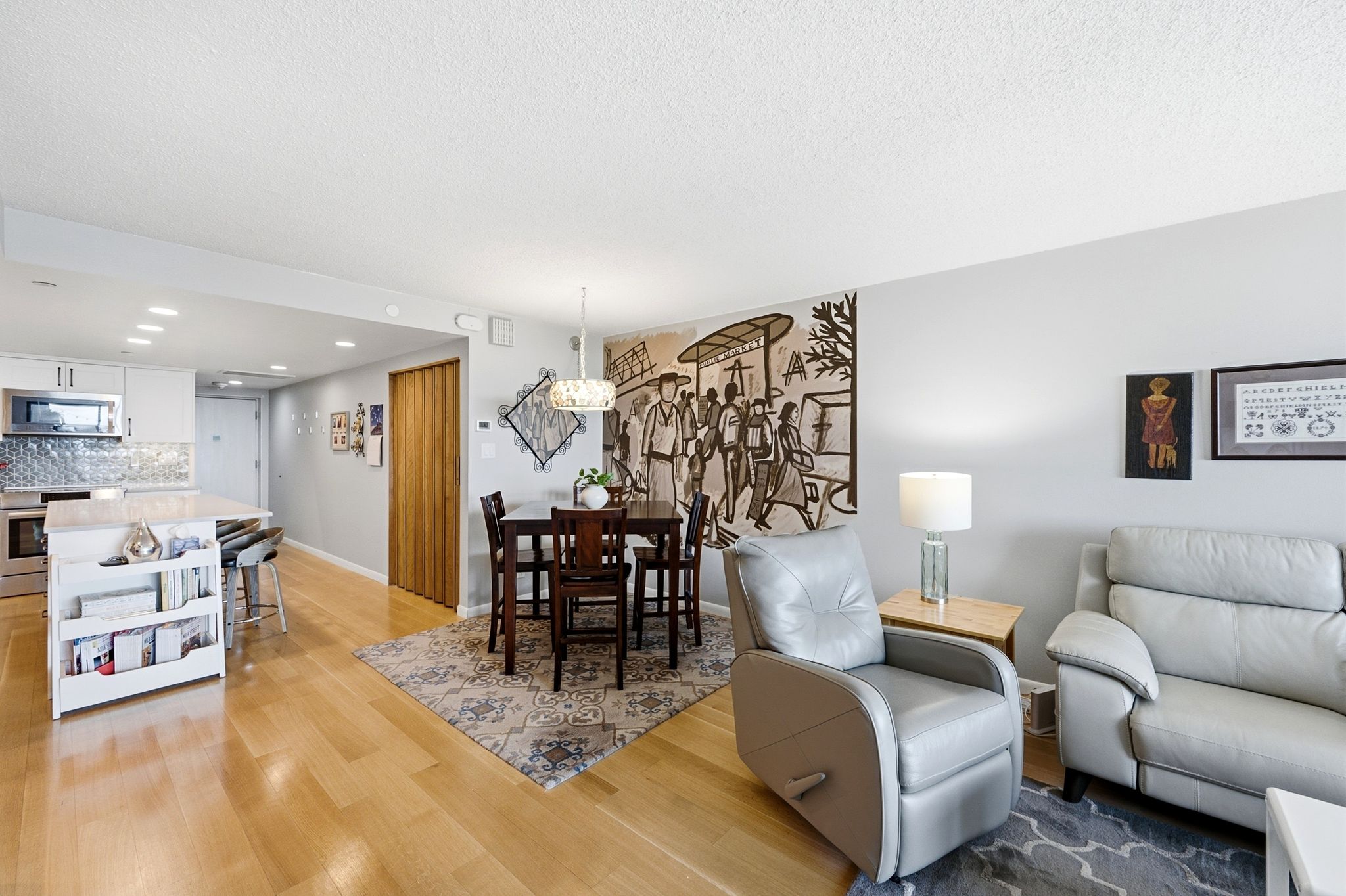 Open-concept living area featuring light wood-finish flooring