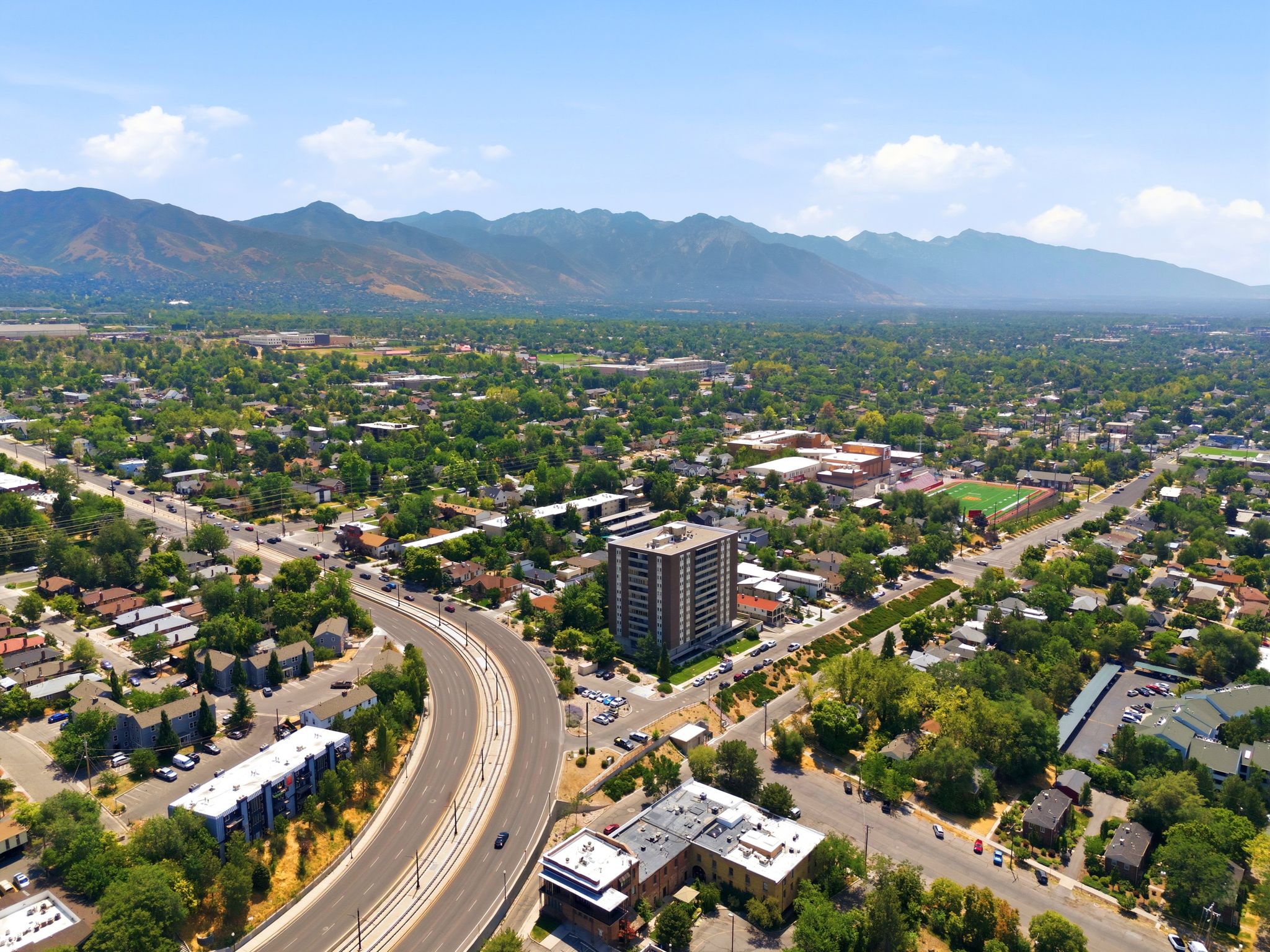 Aerial perspective showcasing a multi-story building within a developed urban area
