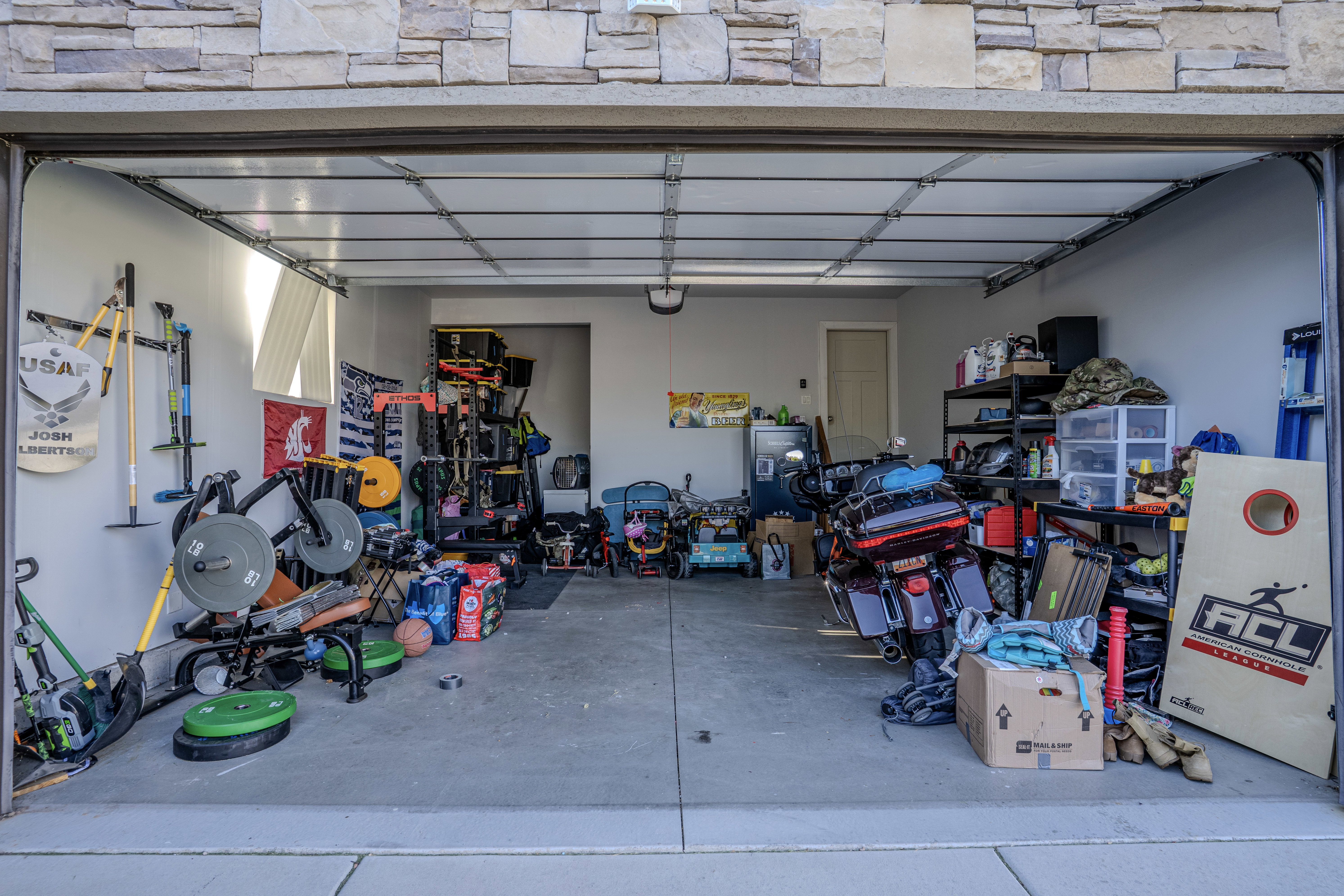 Spacious garage featuring a concrete floor, light gray walls, and an interior door