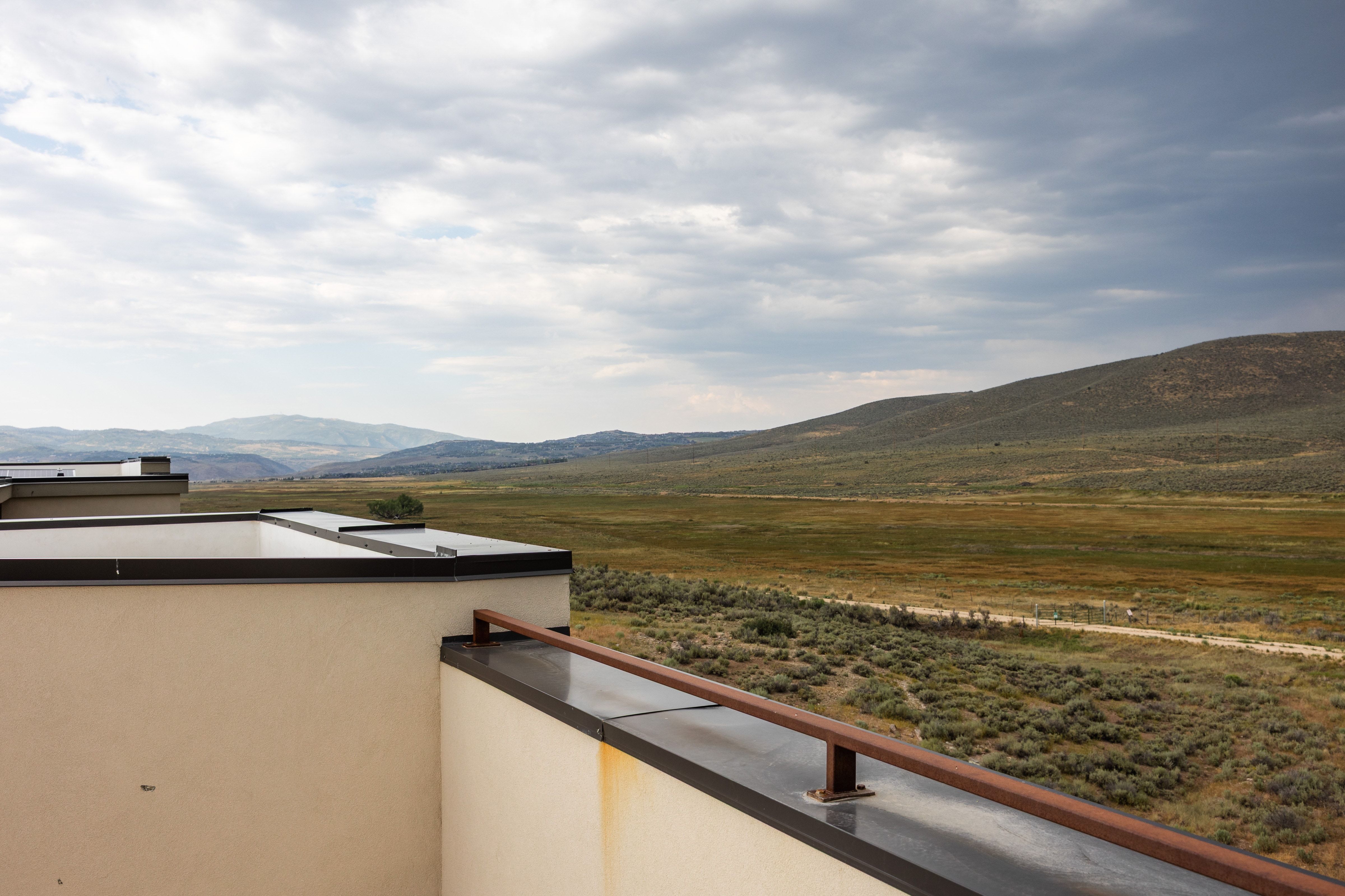 Expansive natural landscape with rolling hills and varied vegetation
