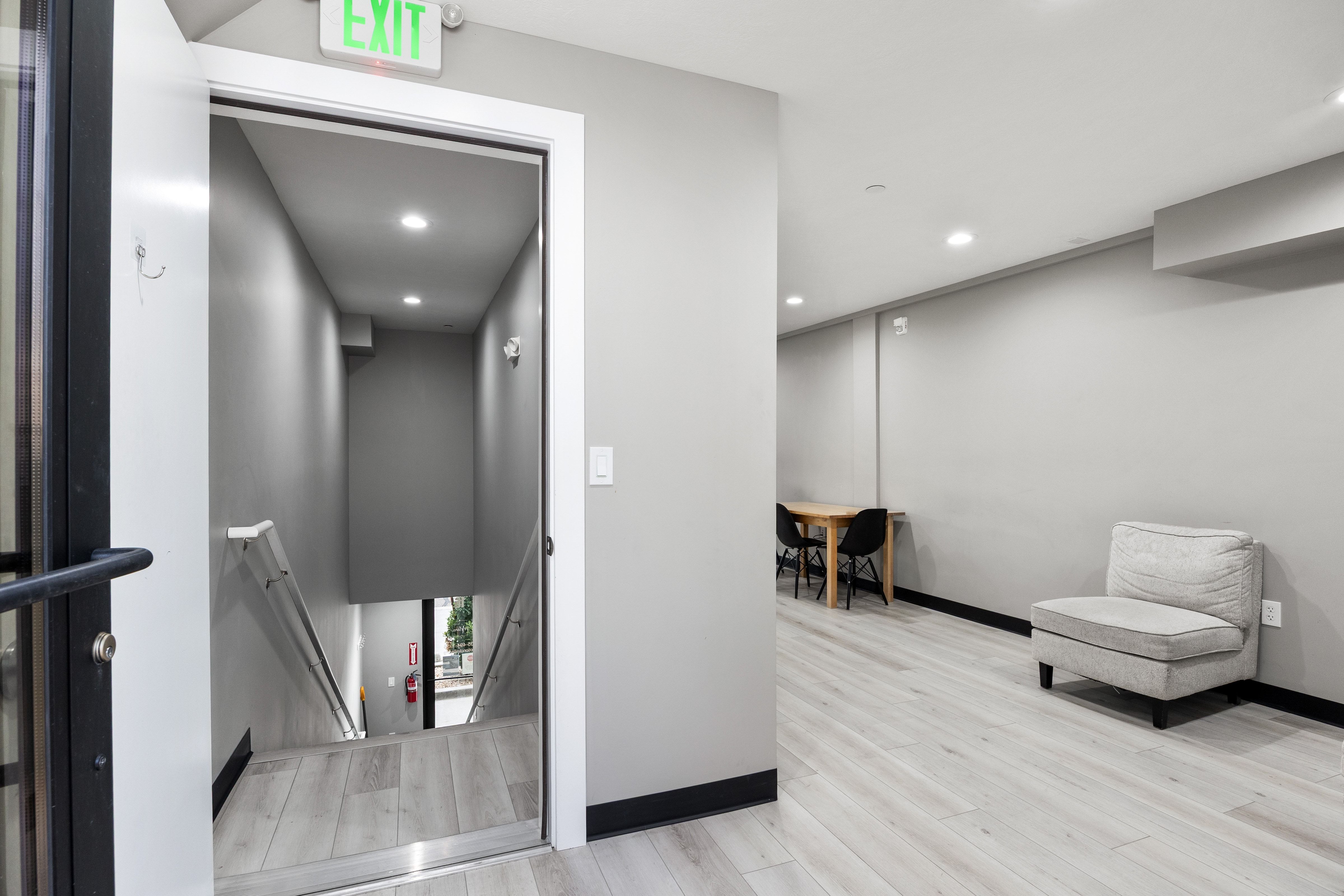 Interior hallway featuring light wood-finish flooring, recessed lighting, and a neutral wall color