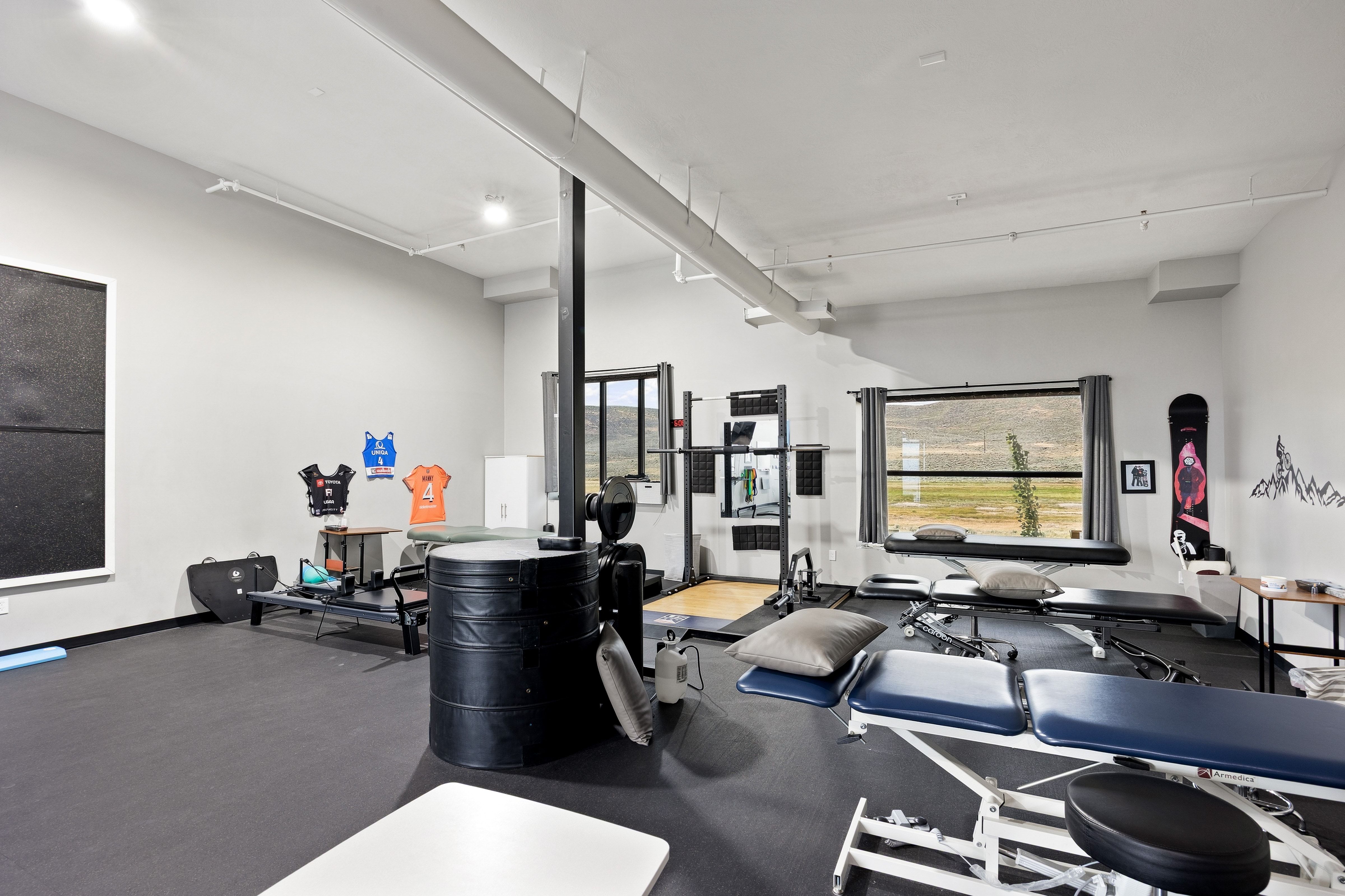 Spacious interior room with light grey walls and dark flooring