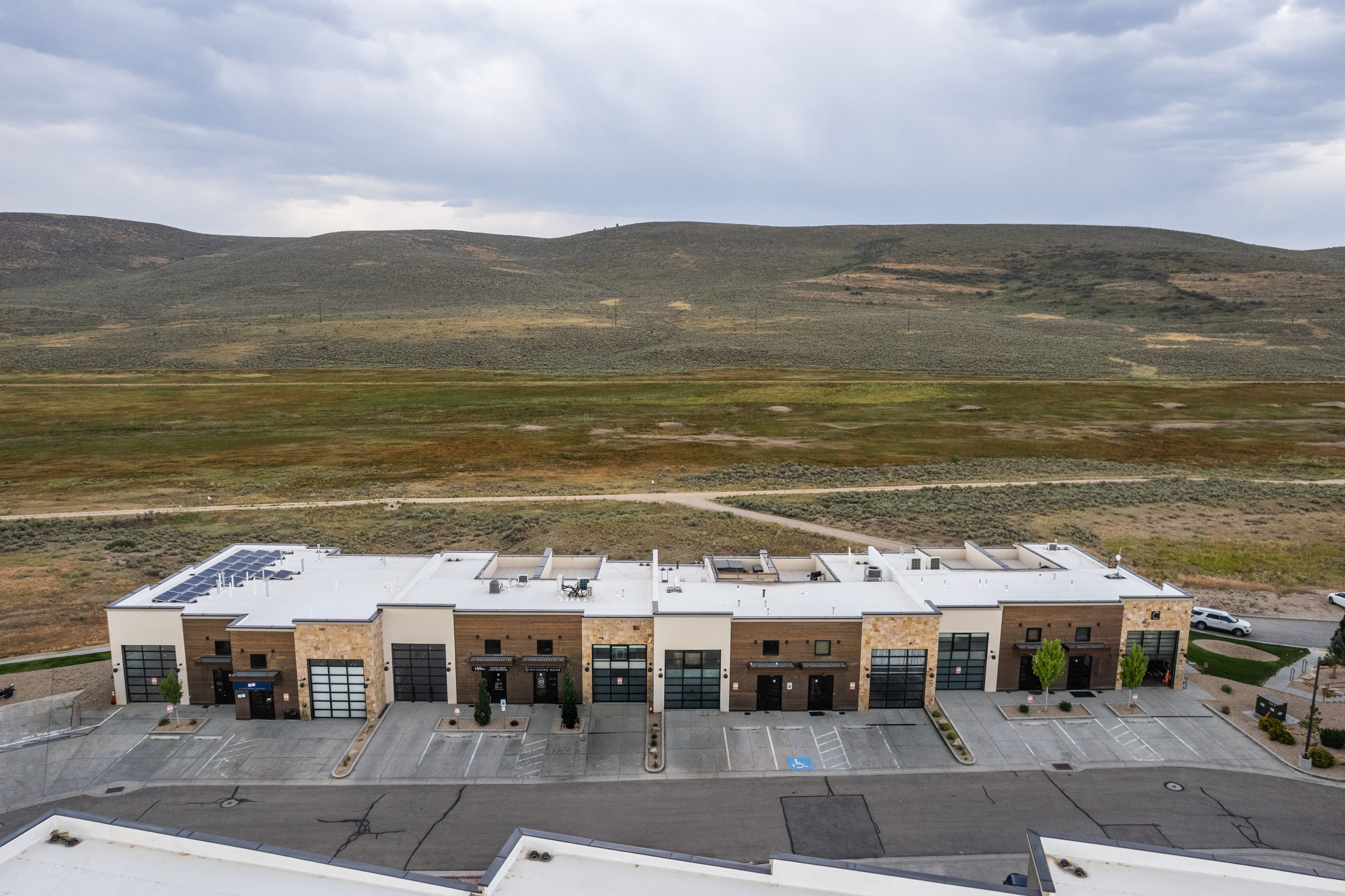 Contemporary townhome exteriors featuring varied stone and paneling finishes