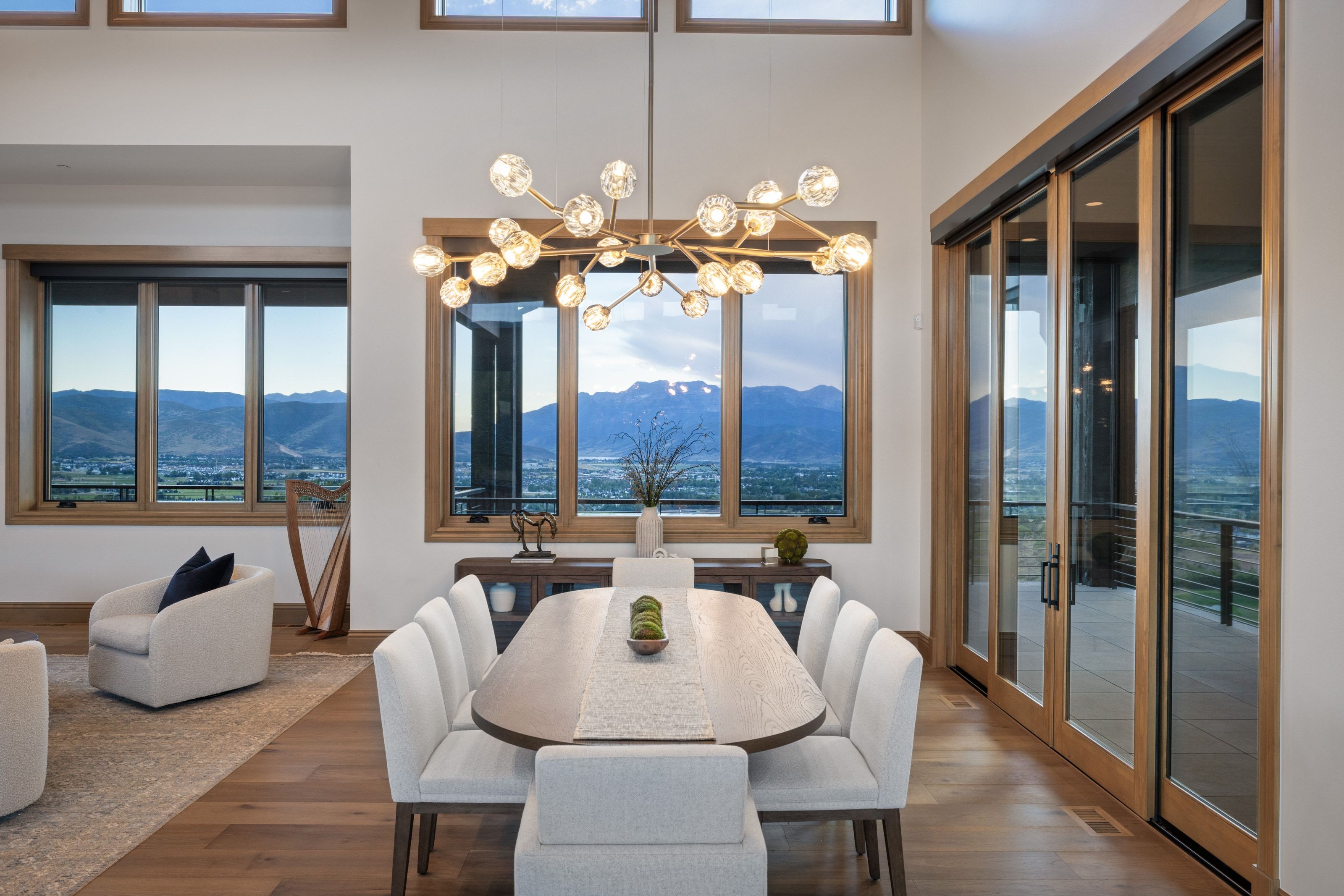 Dining area featuring a contemporary chandelier, wood-finish flooring, and expansive windows