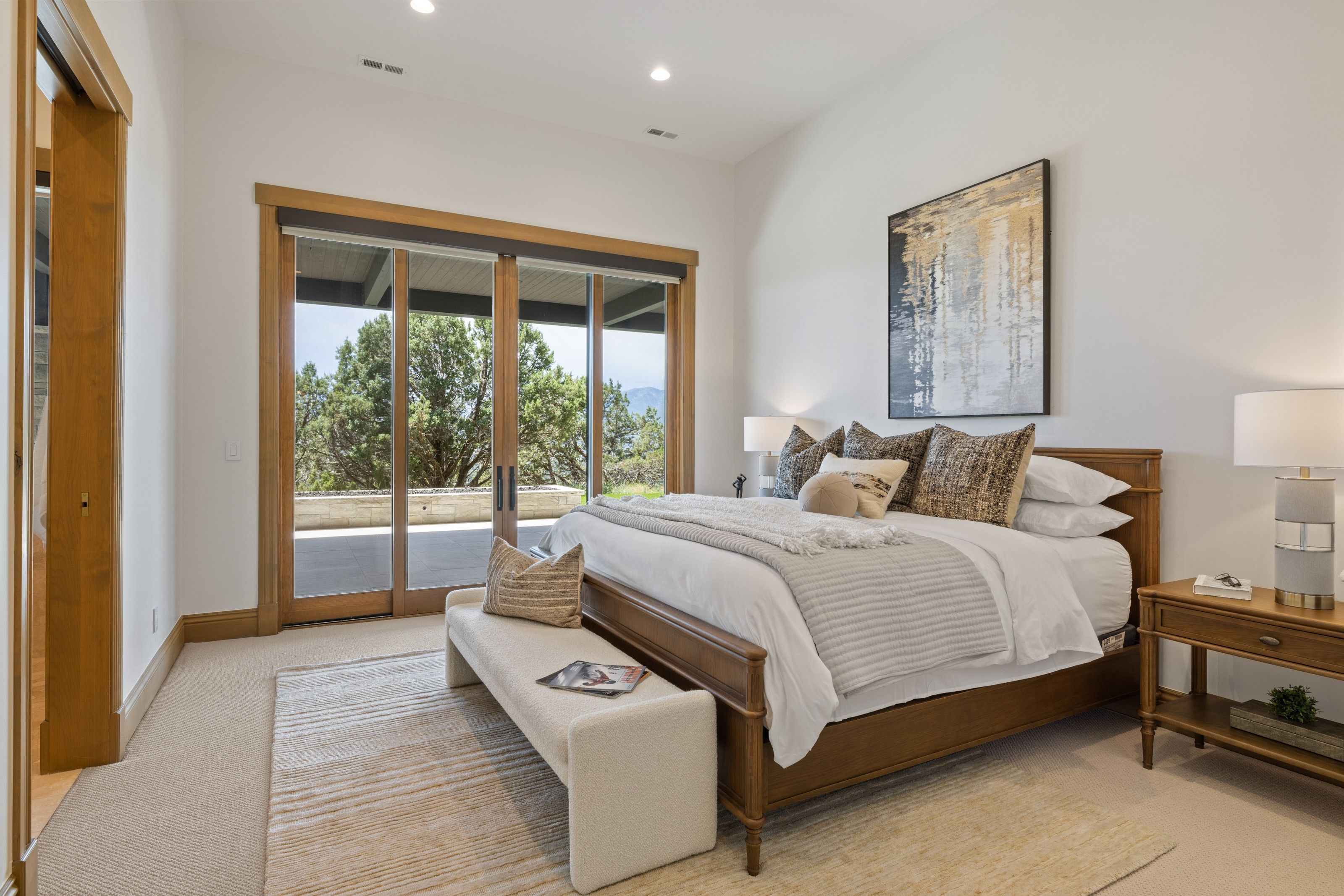 Bedroom featuring expansive glass sliding doors opening to an outdoor patio