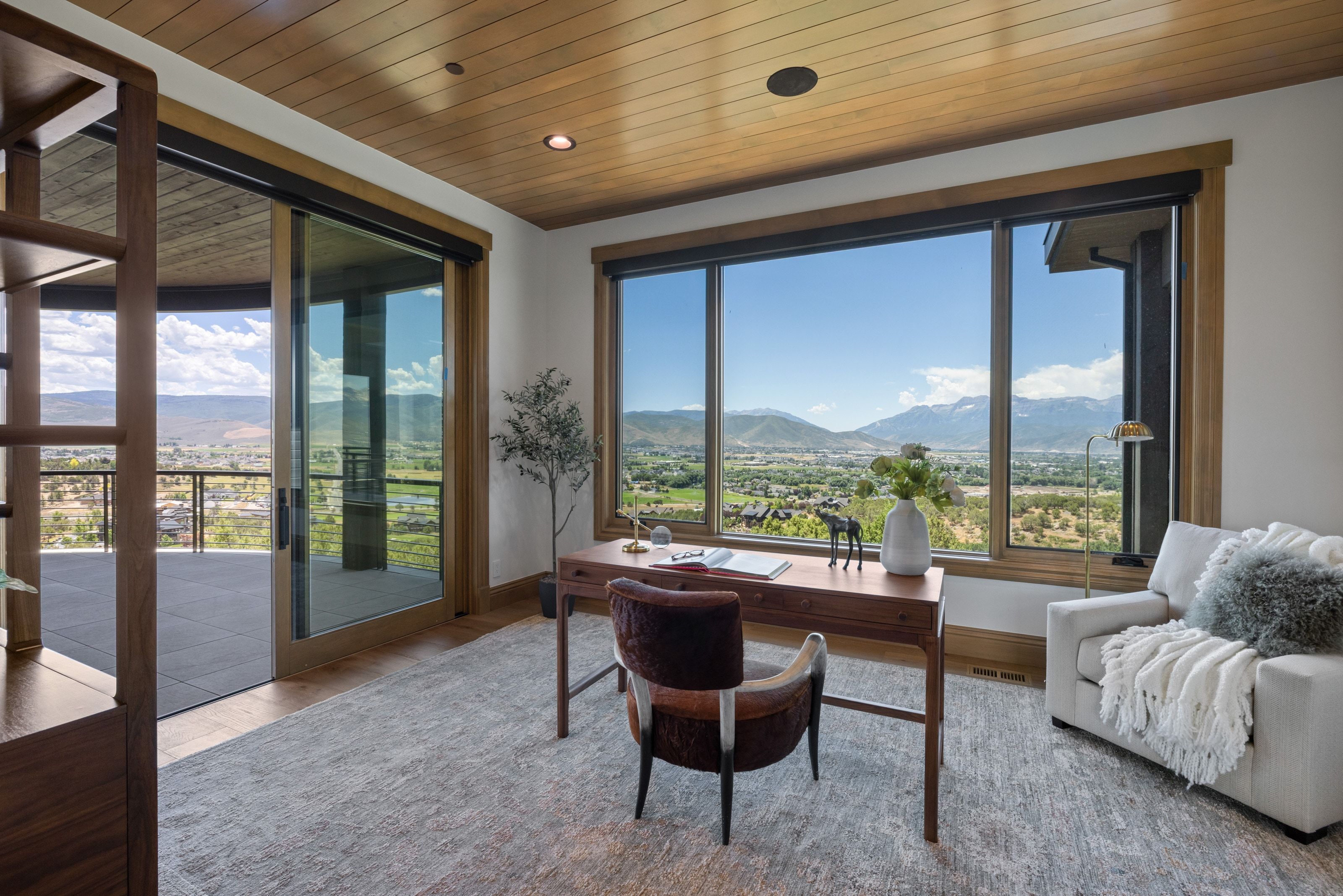 Expansive window wall with mountain and valley scenery