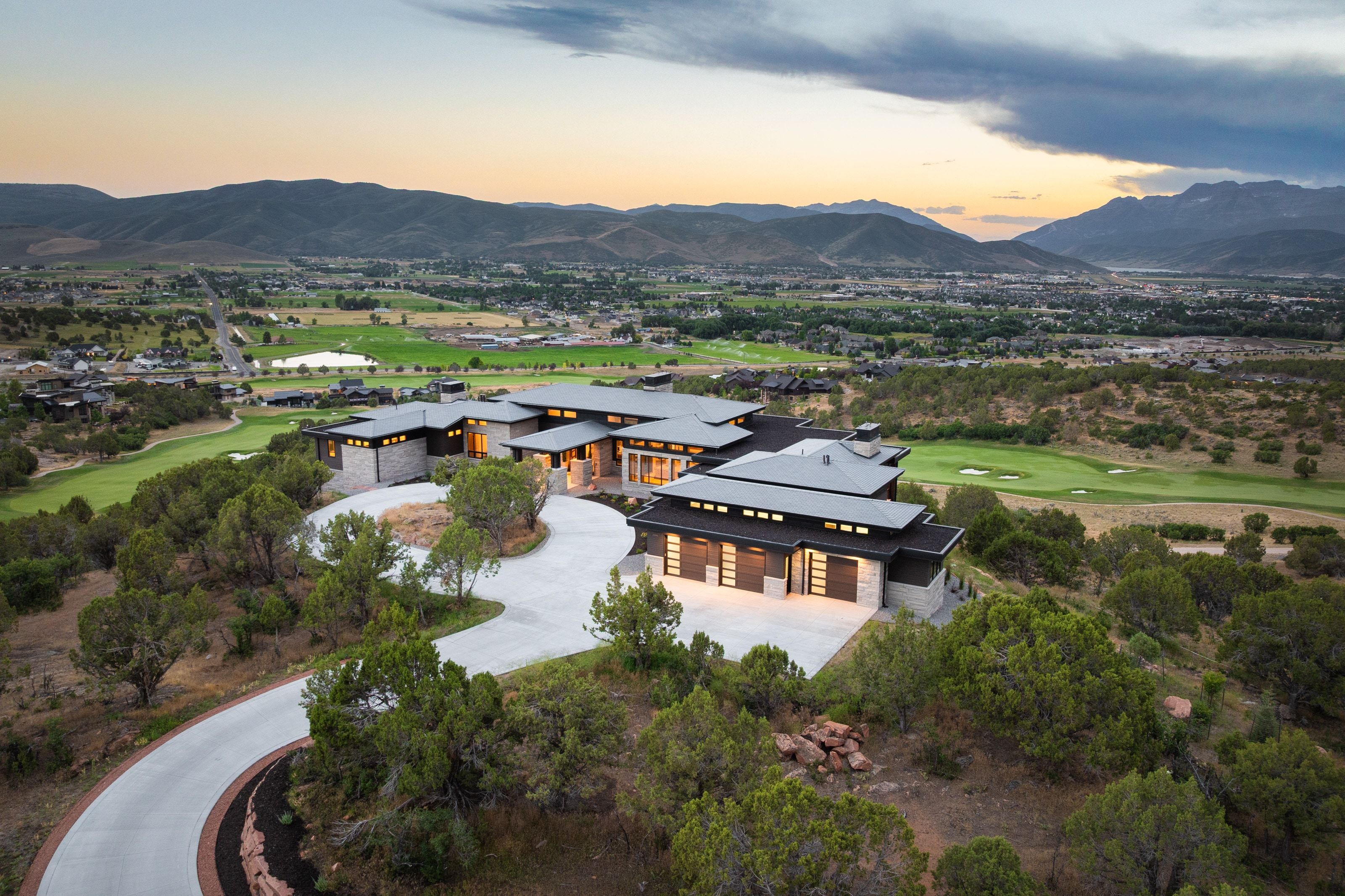 Modern architectural design featuring extensive stone and dark wood-tone accents