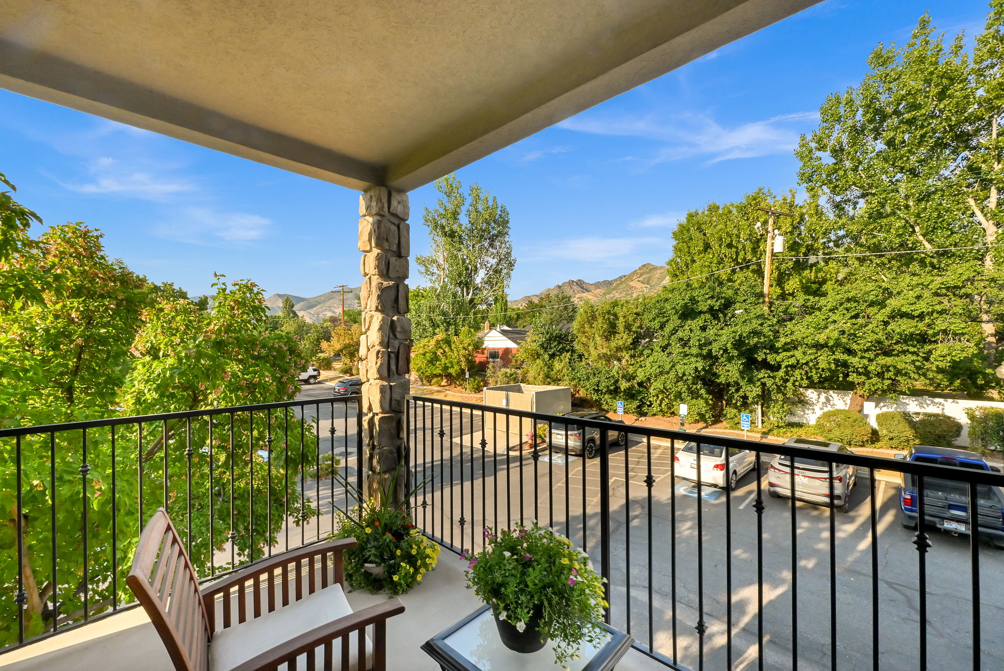 Private outdoor balcony featuring trees and mountain views