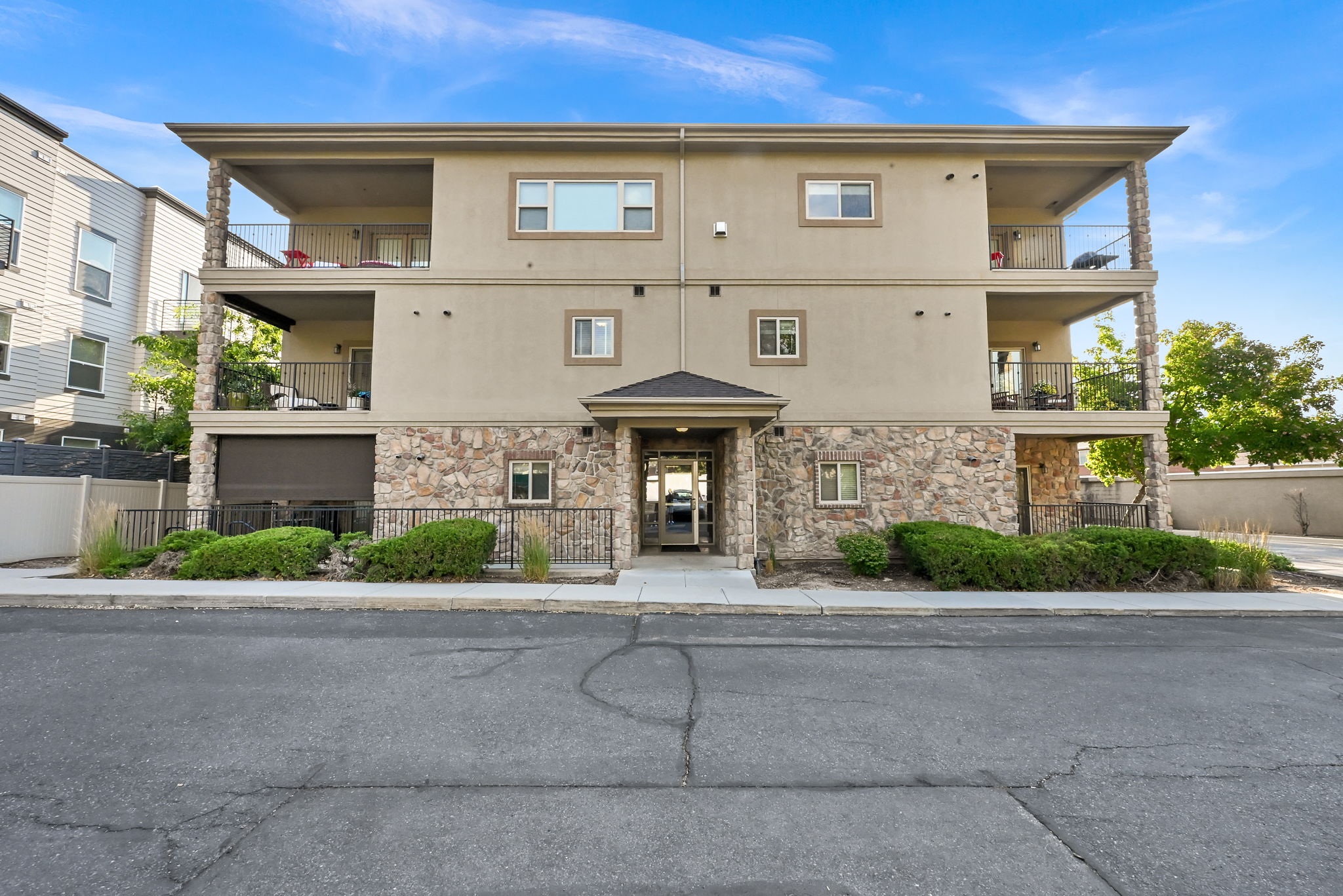 Back Entrance: Multi-story residence featuring a stone and stucco exterior