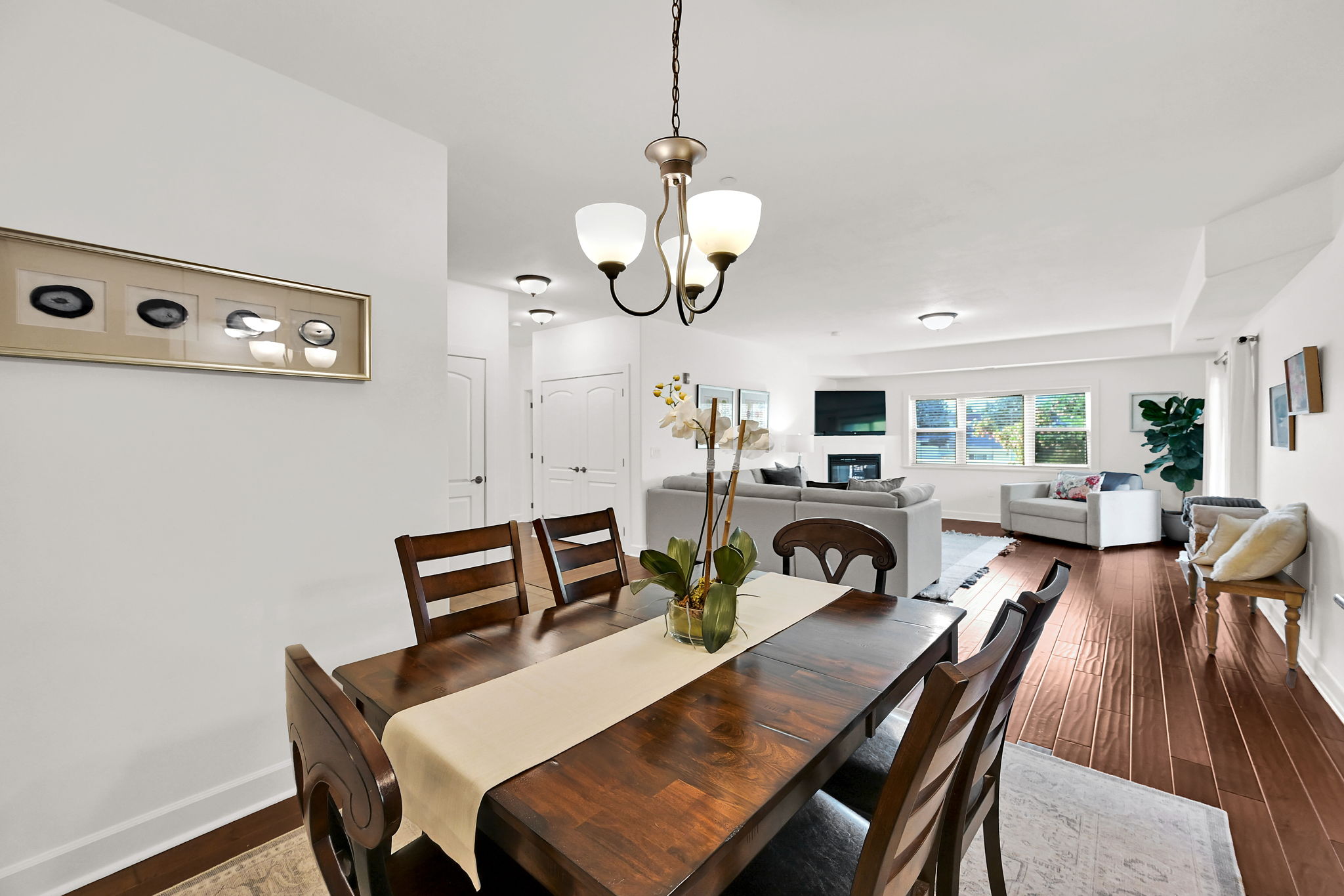Open-concept dining and living area featuring wood flooring