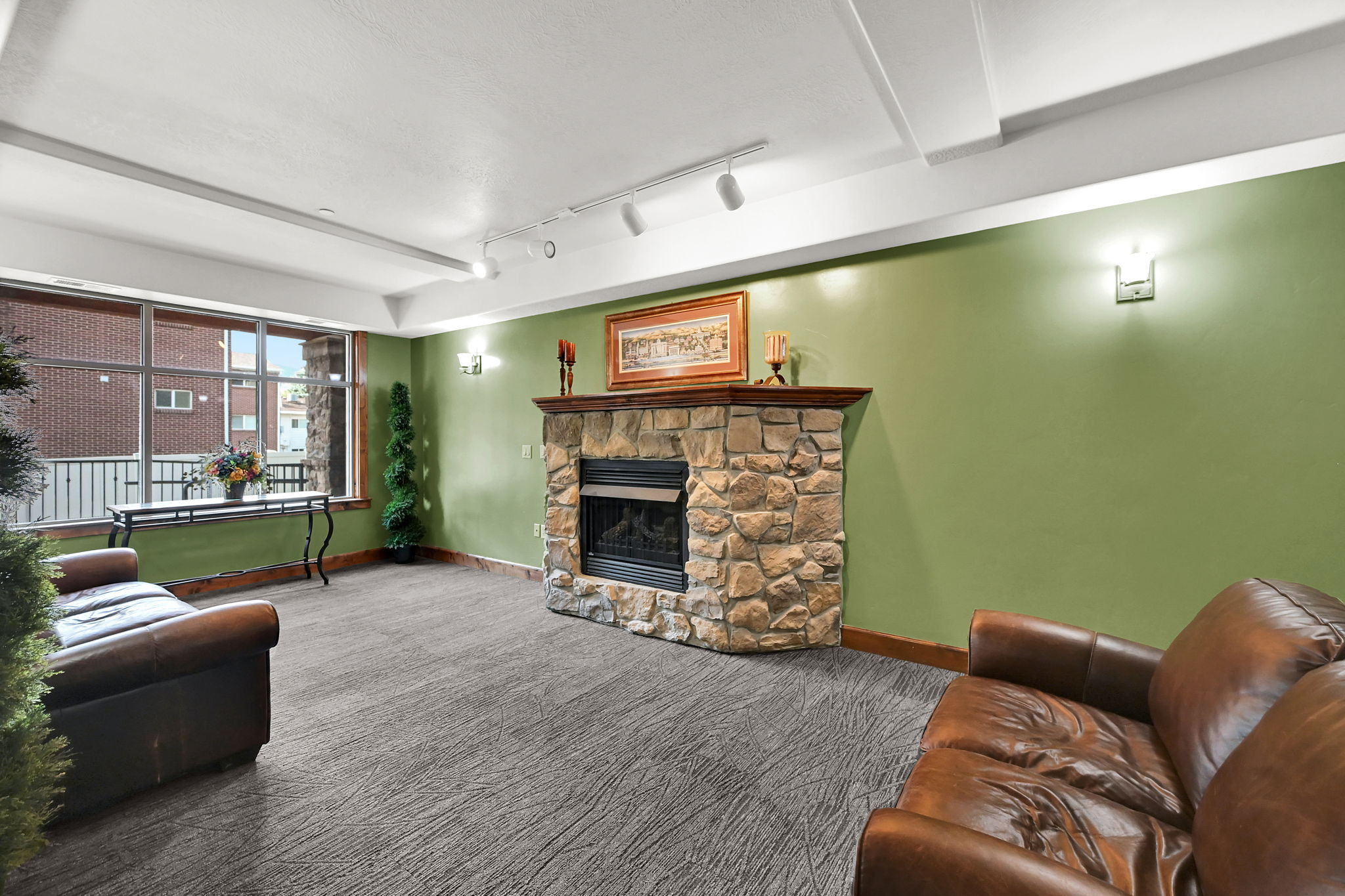 Lobby on Level M: 100 (Main) with Stone fireplace featuring a wood mantel